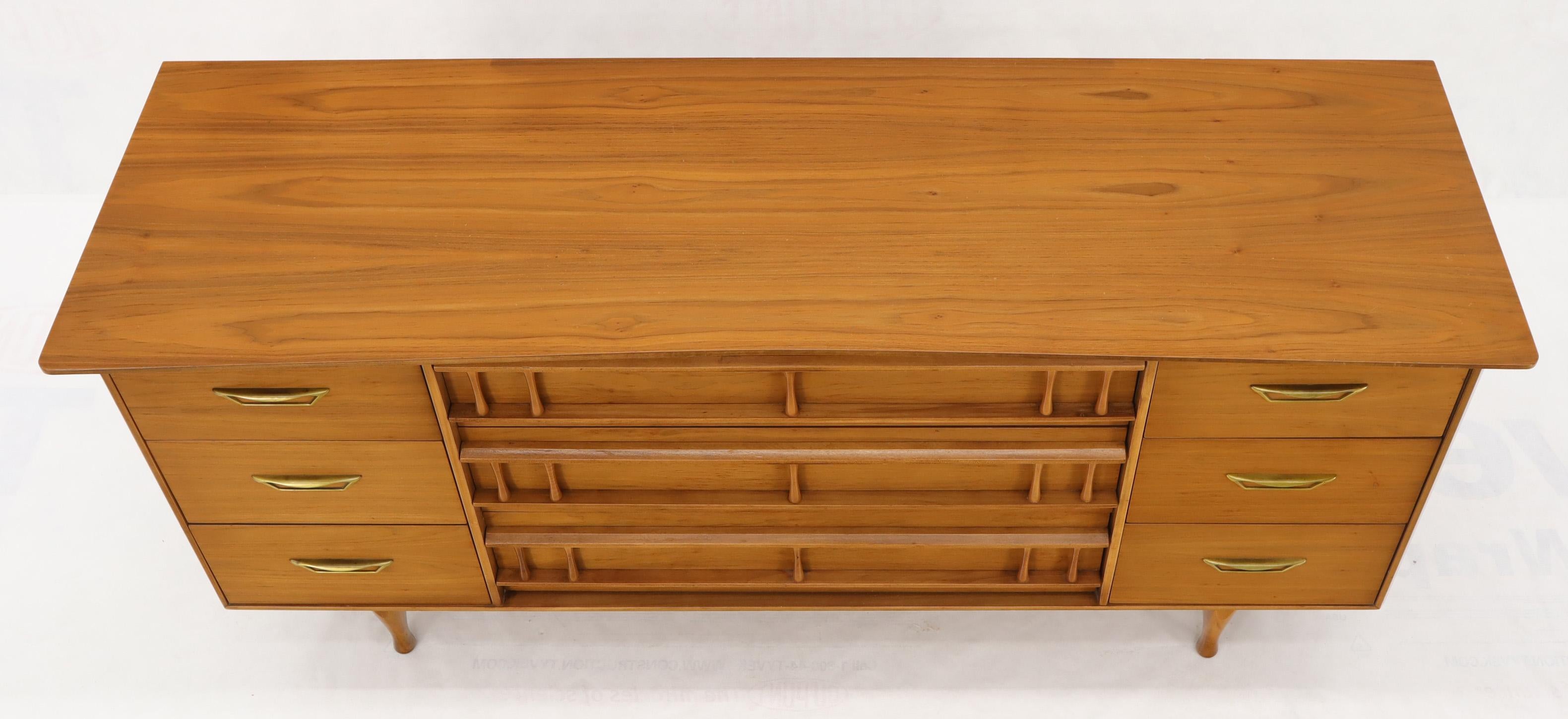 Mid-Century Modern light walnut American dresser credenza on turned dowel legs. Brass hardware pulls.