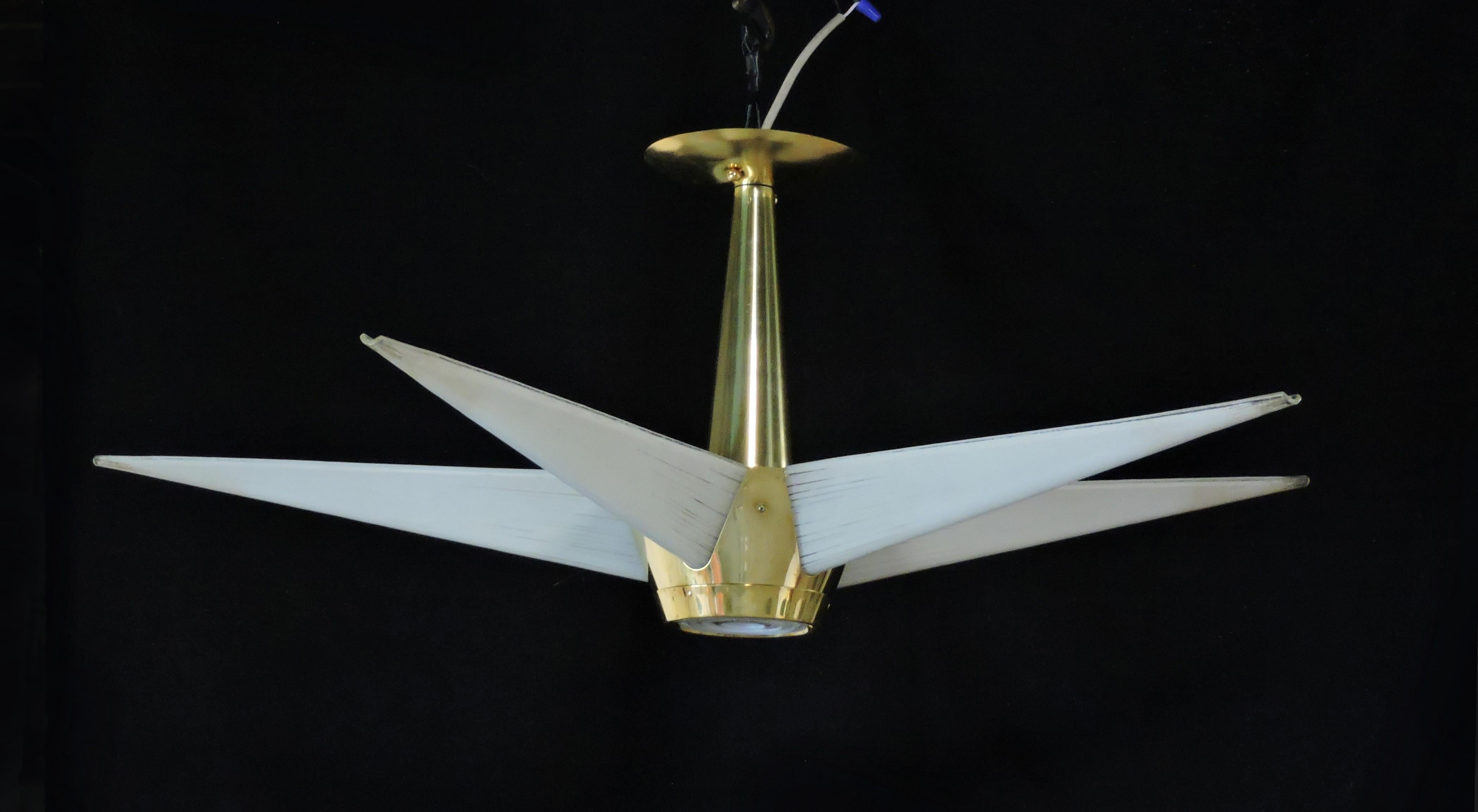 Beautiful and hard to find mid century modern star shaped chandelier made by high quality manufacturer, Lightolier, as part of its Claremont Light series. This lamp has five arms of bent glass which rest in a brass bucket with a fresnel lens on the