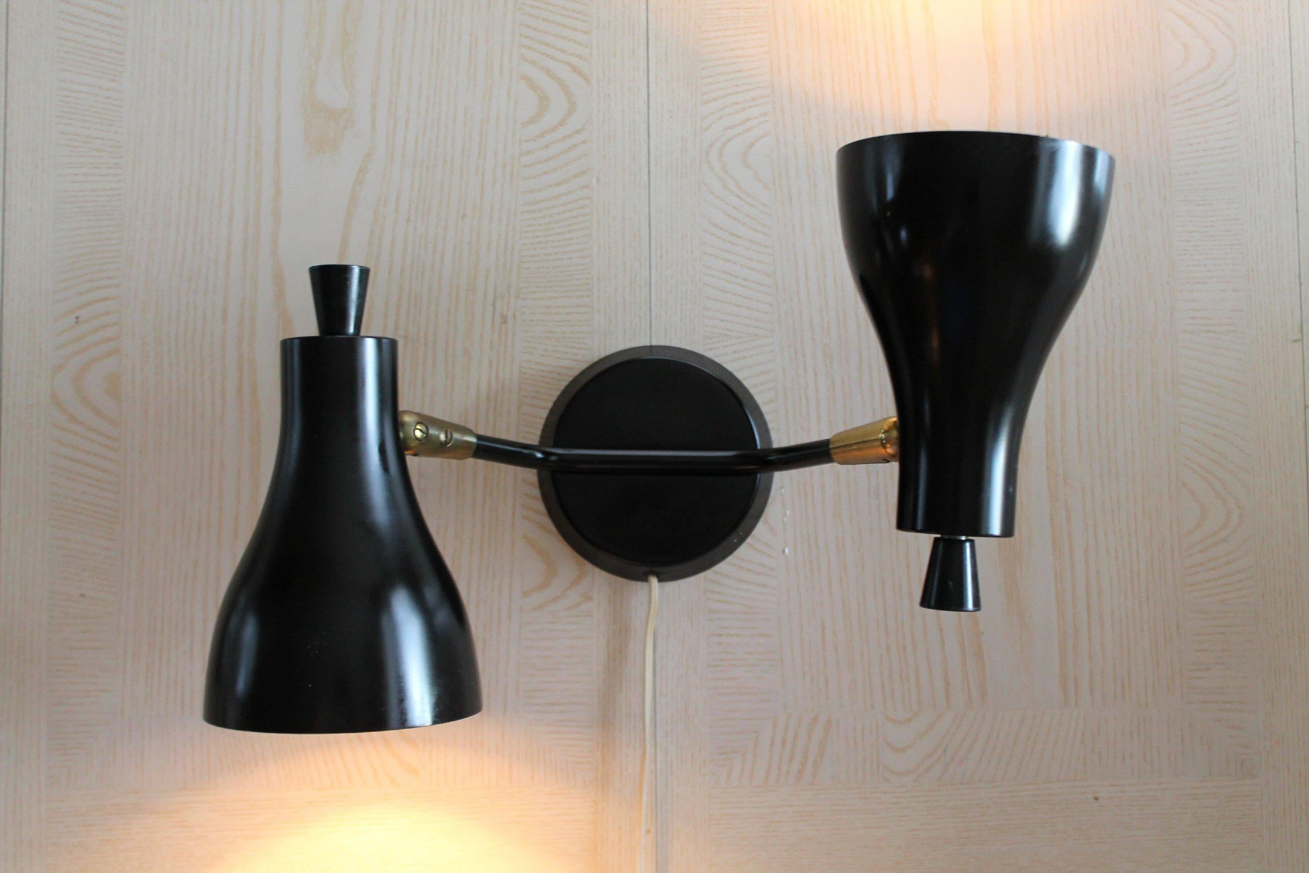 ICONIC!

Simply BEAUTIFUL Black
LIGHTOLIER DUAL SHADE WALL SCONCE
By GERALD THURSTON

Does your Case Study House need new lamps? This marvelous specimen is sure to be a welcome addition!

These lamps, penned by Gerald Thurston the in-house designer
