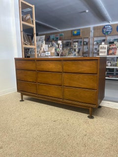 Mid-Century Modern Likely Walnut Nine-Drawer Dresser with Sculpted Pulls.
