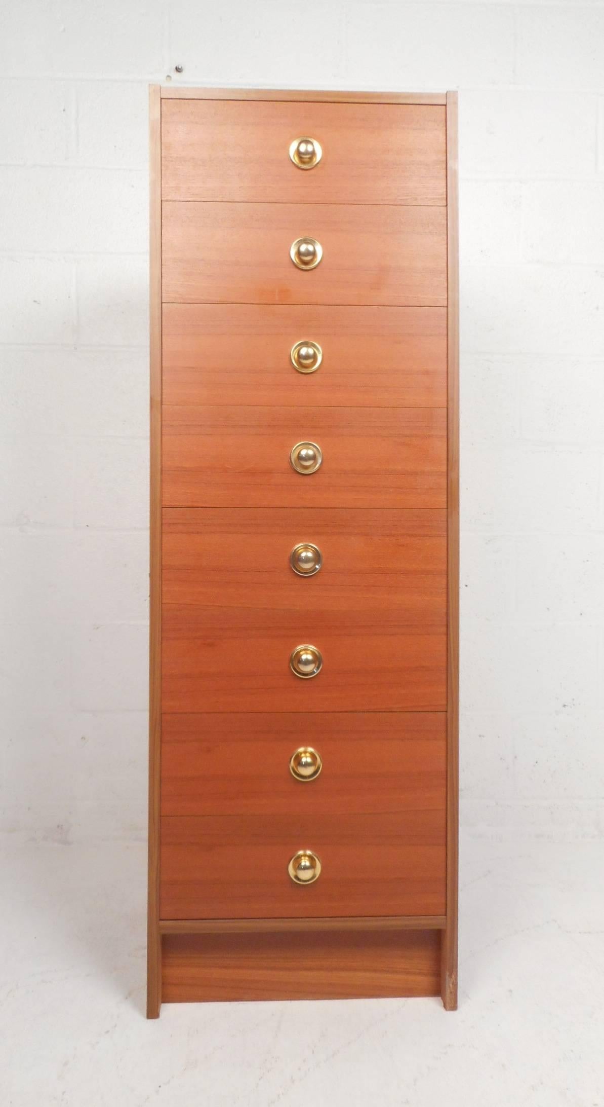 This stylish eight drawer tall chest will make the perfect addition to any modern interior. The unique circular metal drawer pulls and elegant wood grain throughout shows quality craftsmanship. An excellent method for storing plenty of items without