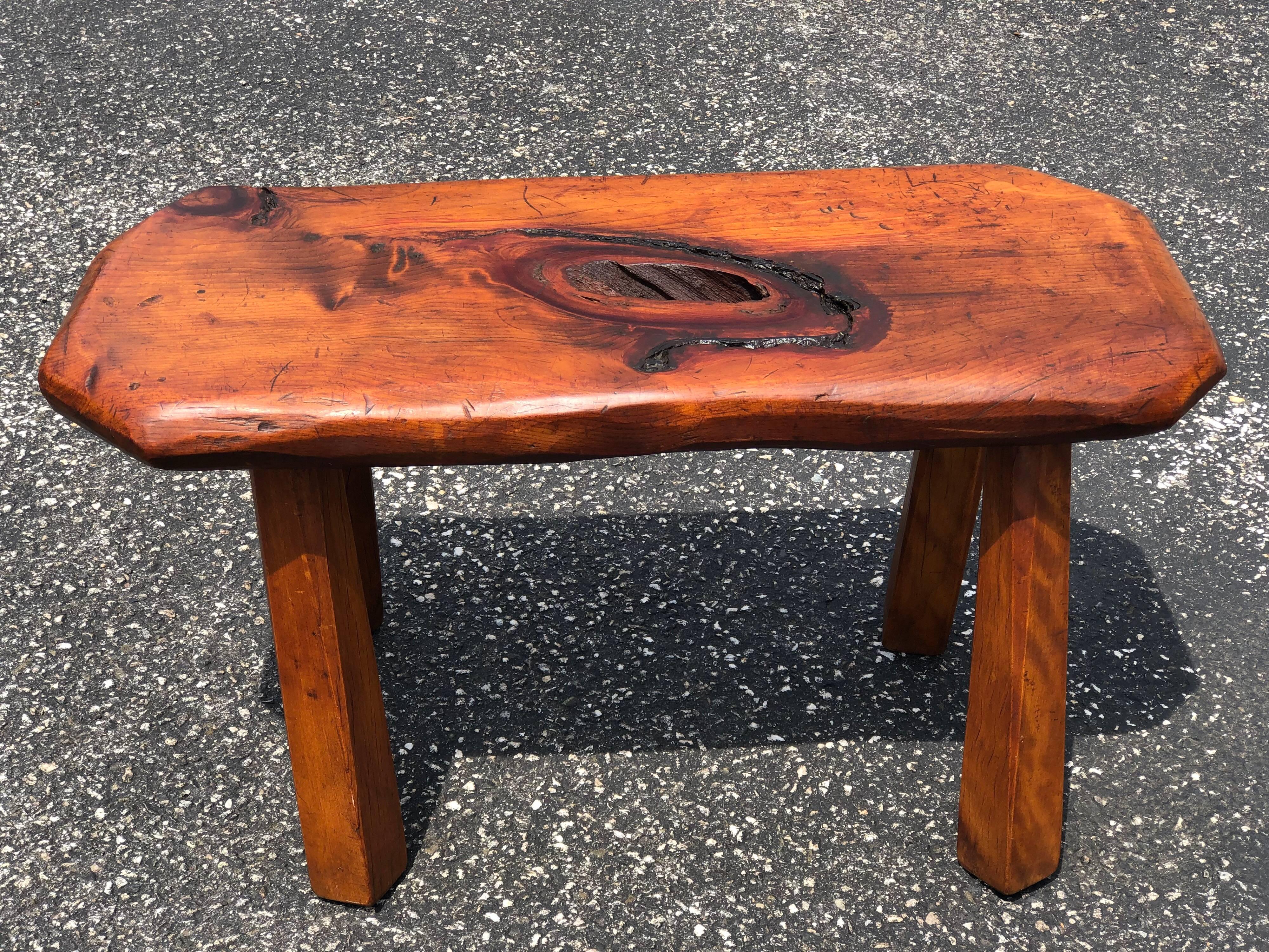 Mid-Century Modern live edge bench or table. We think this may be made of black walnut. Very nice design and easy size to find a place for. Use as a bench, stool or table. It has a knot hole in the middle of the stool seat. It is numbered