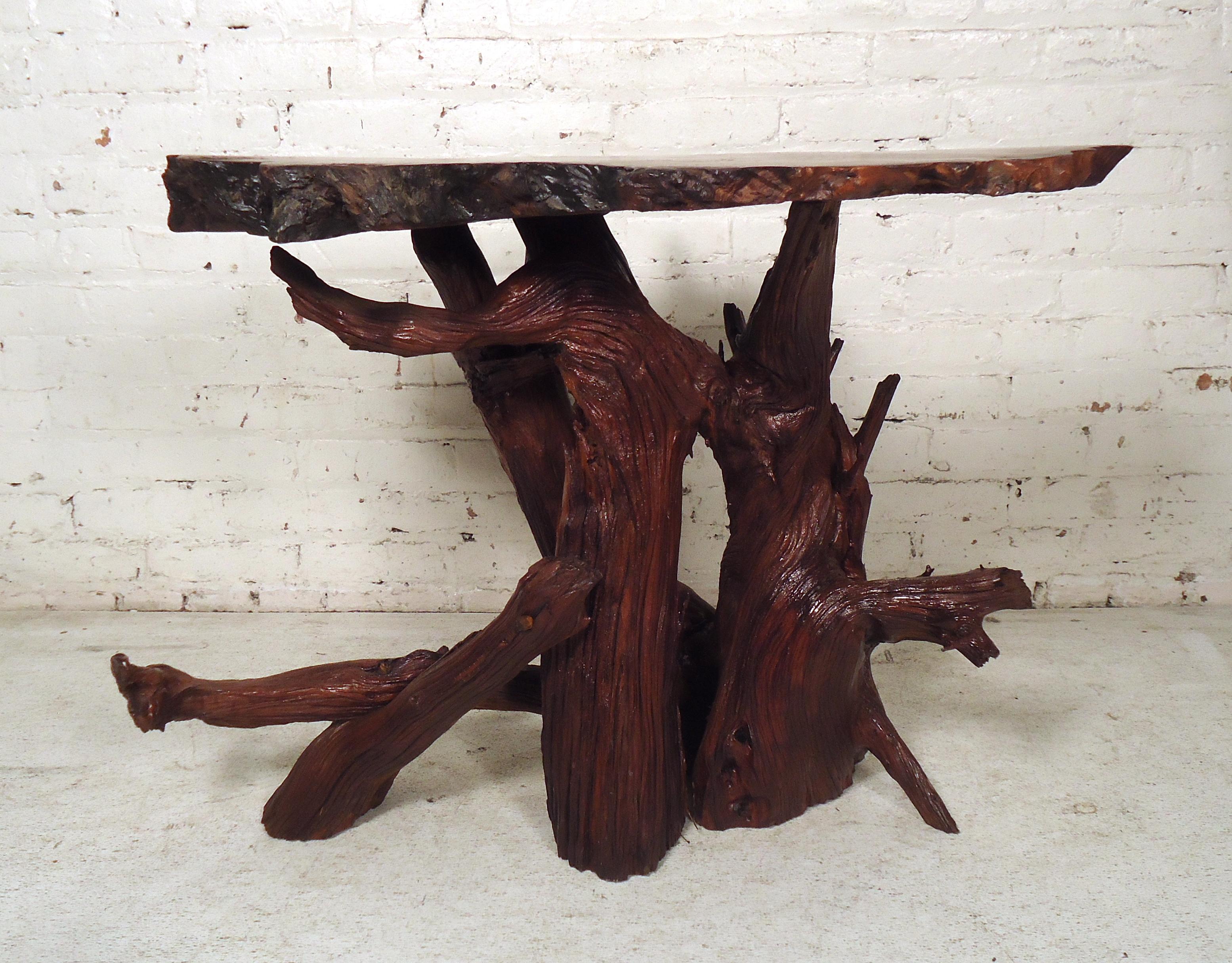 This gorgeous vintage modern coffee table features natural hardwood construction with a unique tree slab top. The vintage rustic appeal is sure to make an impression in any modern interior. Please confirm item location (NY or NJ).