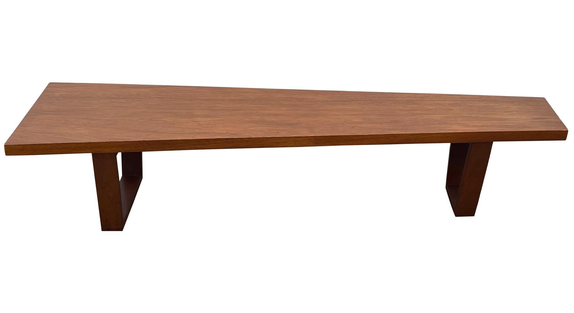 A beautifully made long bench or cocktail table circa 1960's. It feature a well proportioned asymmetrical design with solid wood construction. Very clean and ready to use.