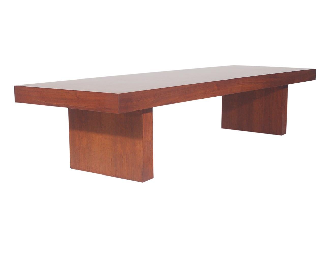 A simple and gorgeous coffee table by Showpieces Inc. in the 1960s. It features all wood construction with a beautifully grained walnut finish. Table has been recently restored. Can be used as bench or long cocktail table.