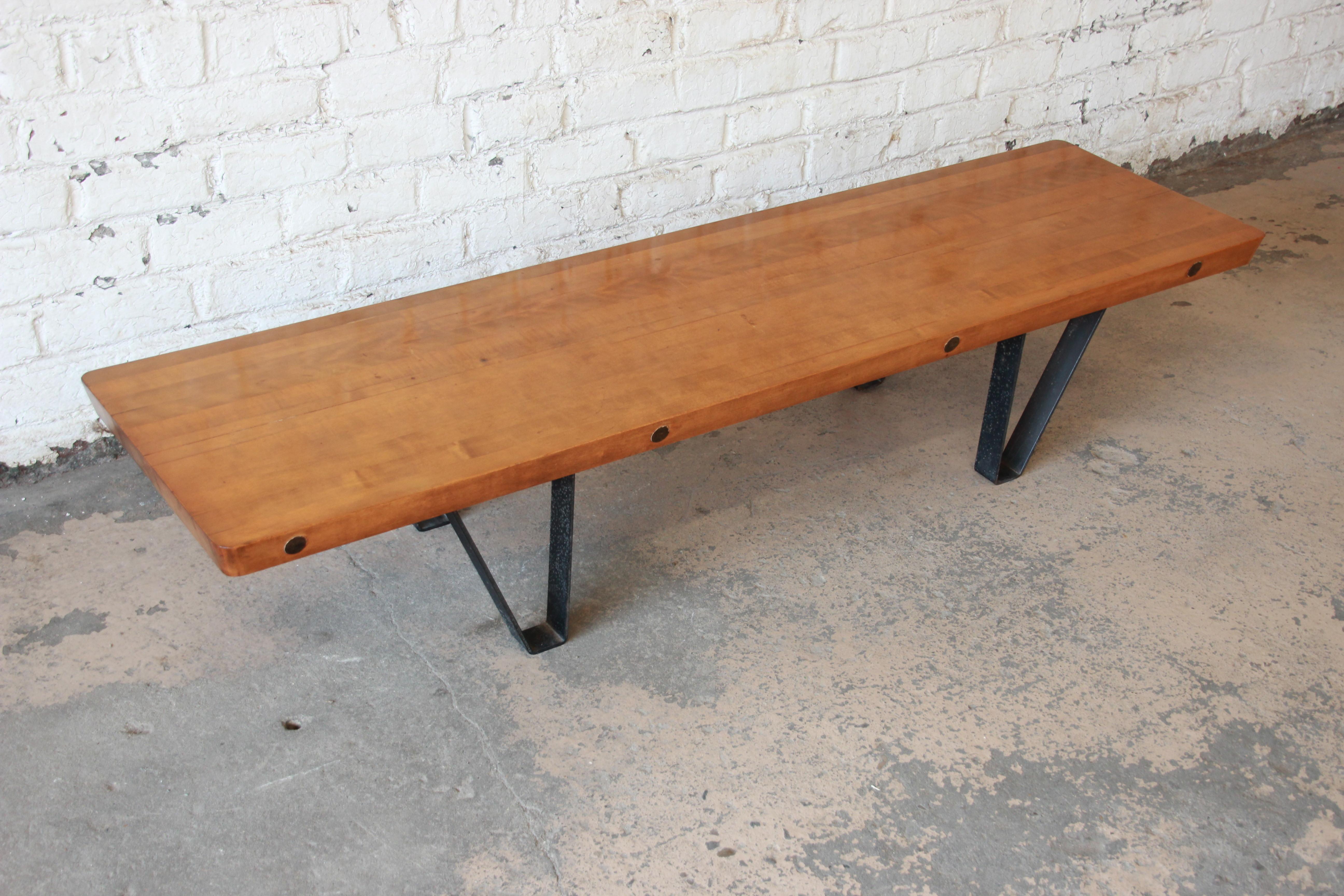 Offering a unique and one of kind vintage Mid-Century Modern long bench or coffee table with a bowling lane top. The legs are cast iron making the table very sturdy with the heavy bowling lane top. The table has sleep midcentury design and is fit to