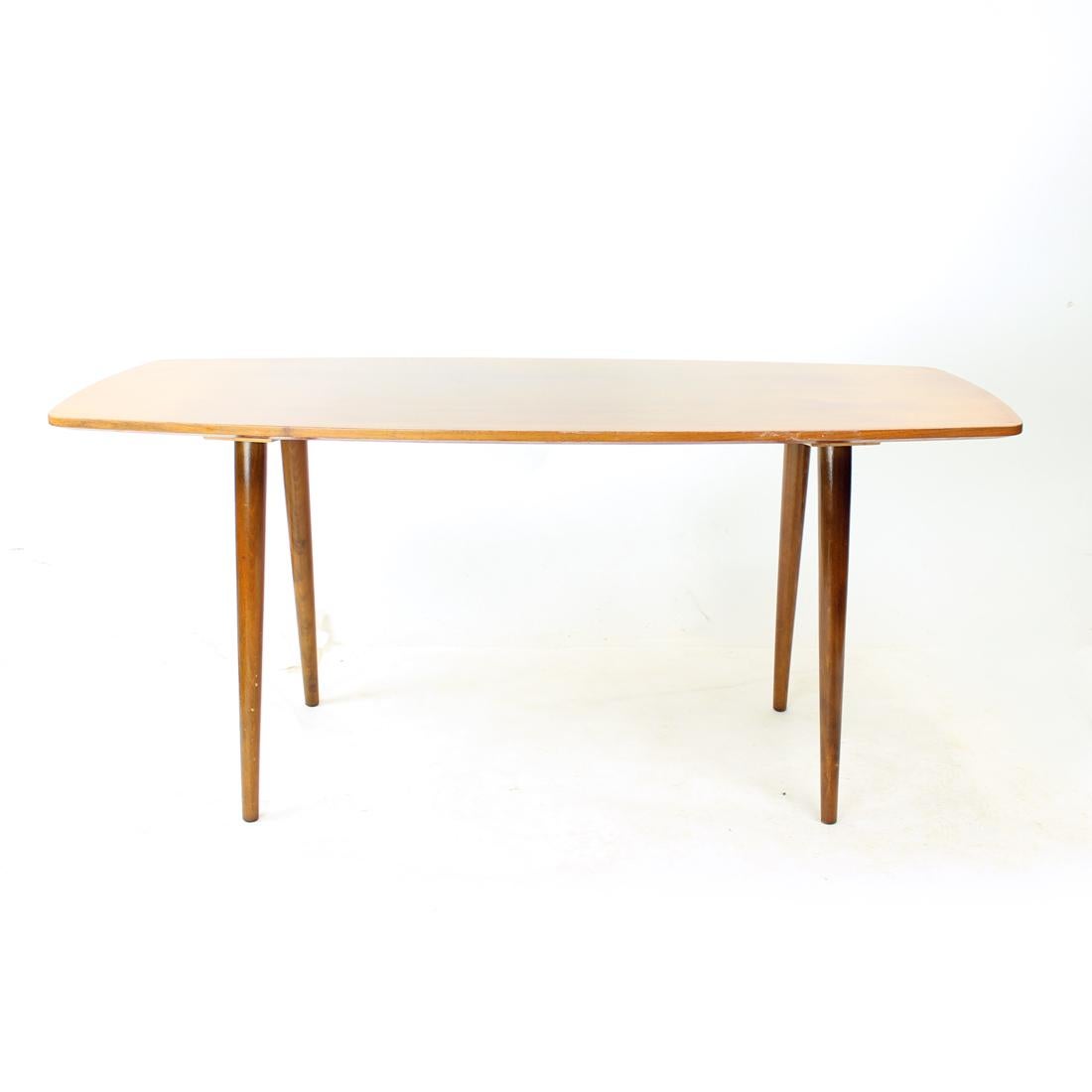 Beautiful vintage coffee table from the mid-century modern design era. Absolutely typical of the 60s designs. The table is made of oak board with oak legs. The top board in finished in an original high sheen lacquer with only few marks of use. Some