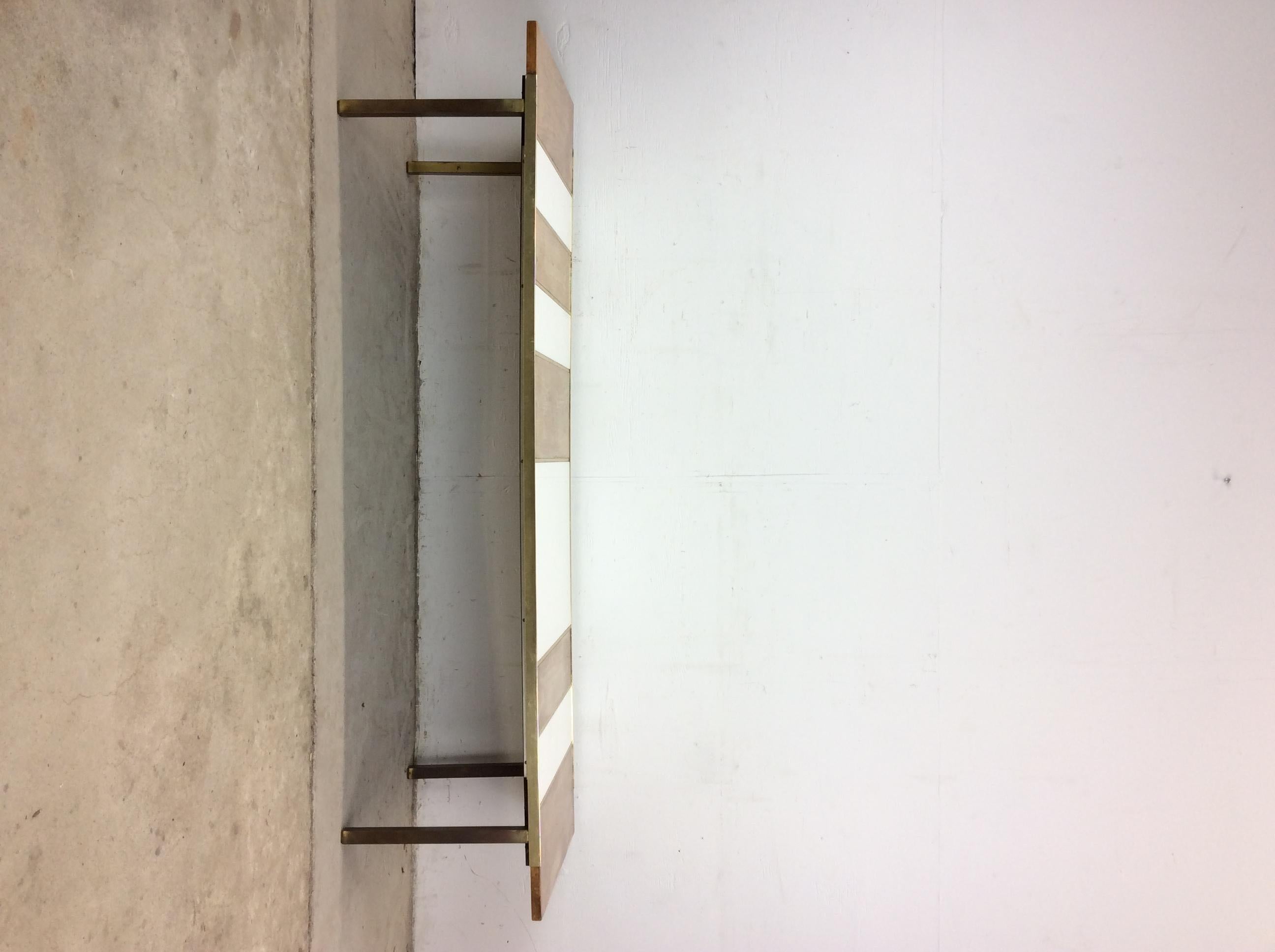 This mid century modern coffee table features hardwood top with white lacquer inlay, brass accented base and legs.   Matching pair of end tables available separately. 

Dimensions: 66w 20.25d 14.75h

Condition notes: Original wood finish is very