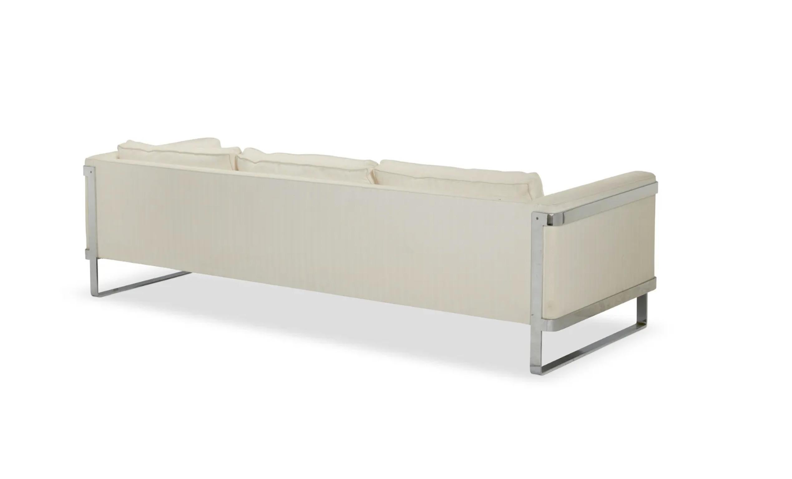 Beautiful Mid-Century Modern 3 seat long low sofa with flat bar chrome metal base designed by Milo Baughman for Thayer Coggin. Beautiful shape with herringbone cream white upholstery. Sits on chrome flat bar base. Good used vintage condition. Made