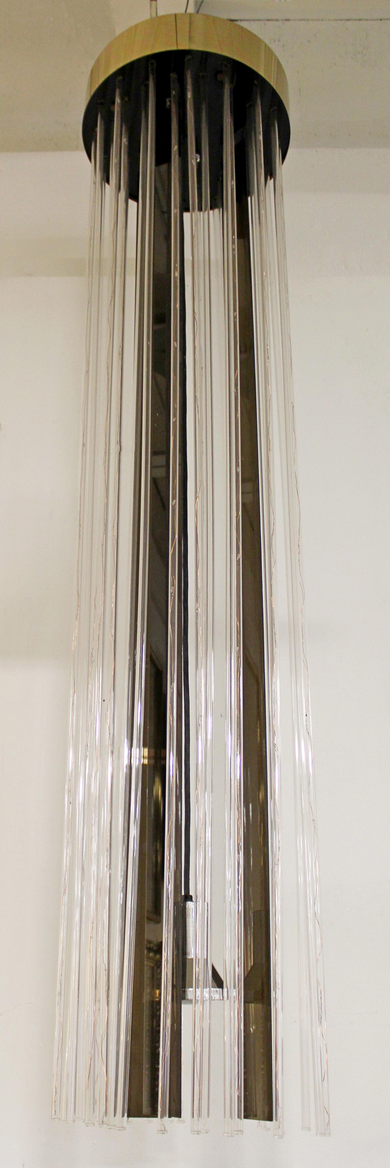 For your consideration is an absolutely fabulous, long hanging chandelier, made of brass and acrylic, circa the 1960s. In very good vintage condition. The dimensions are 16