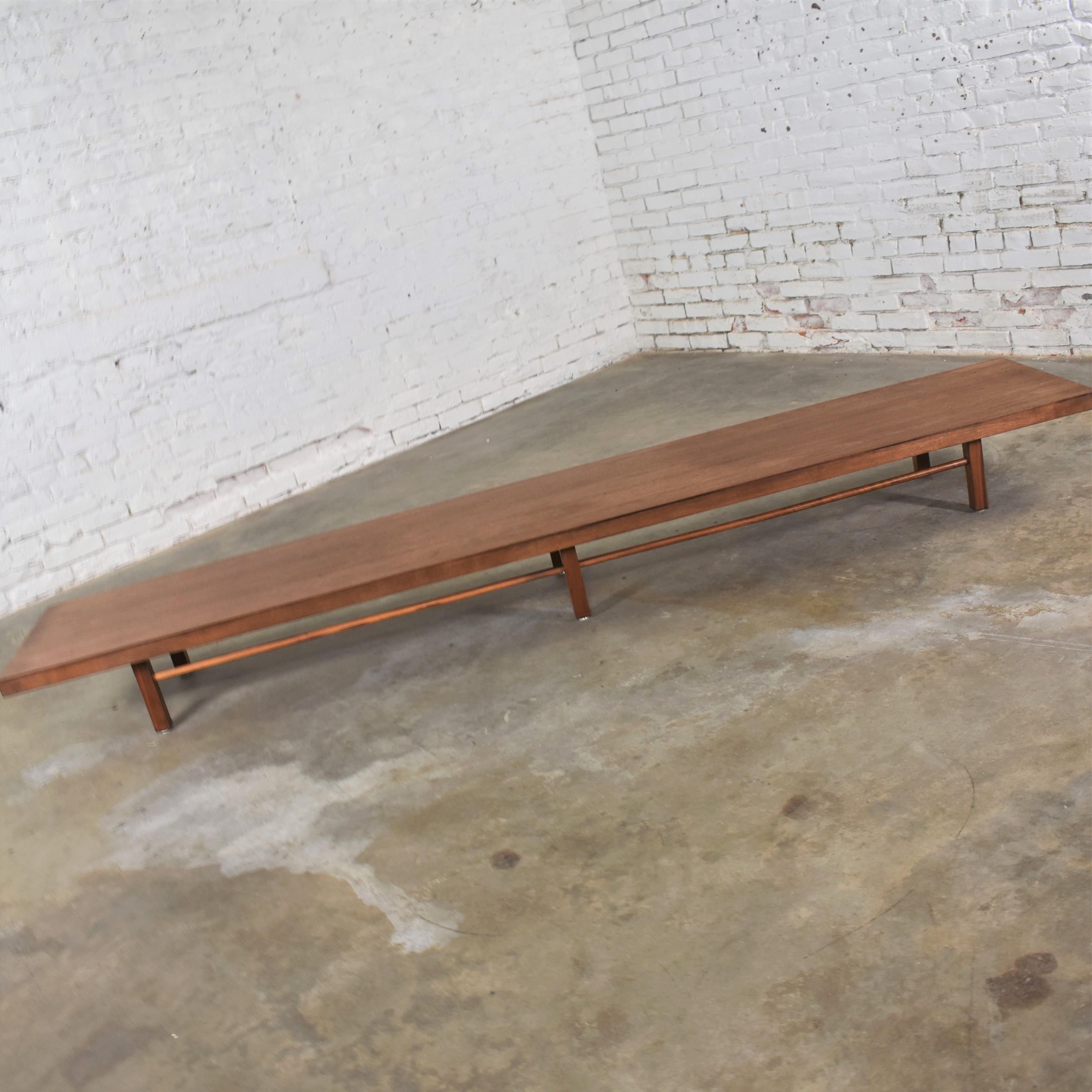Handsome extra-long and low Mid-Century Modern coffee table or stretcher bench designed by Milo Baughman for Thayer Coggin. It is in wonderful restored condition. That does not mean it looks brand new. It retains a beautiful age patina that may