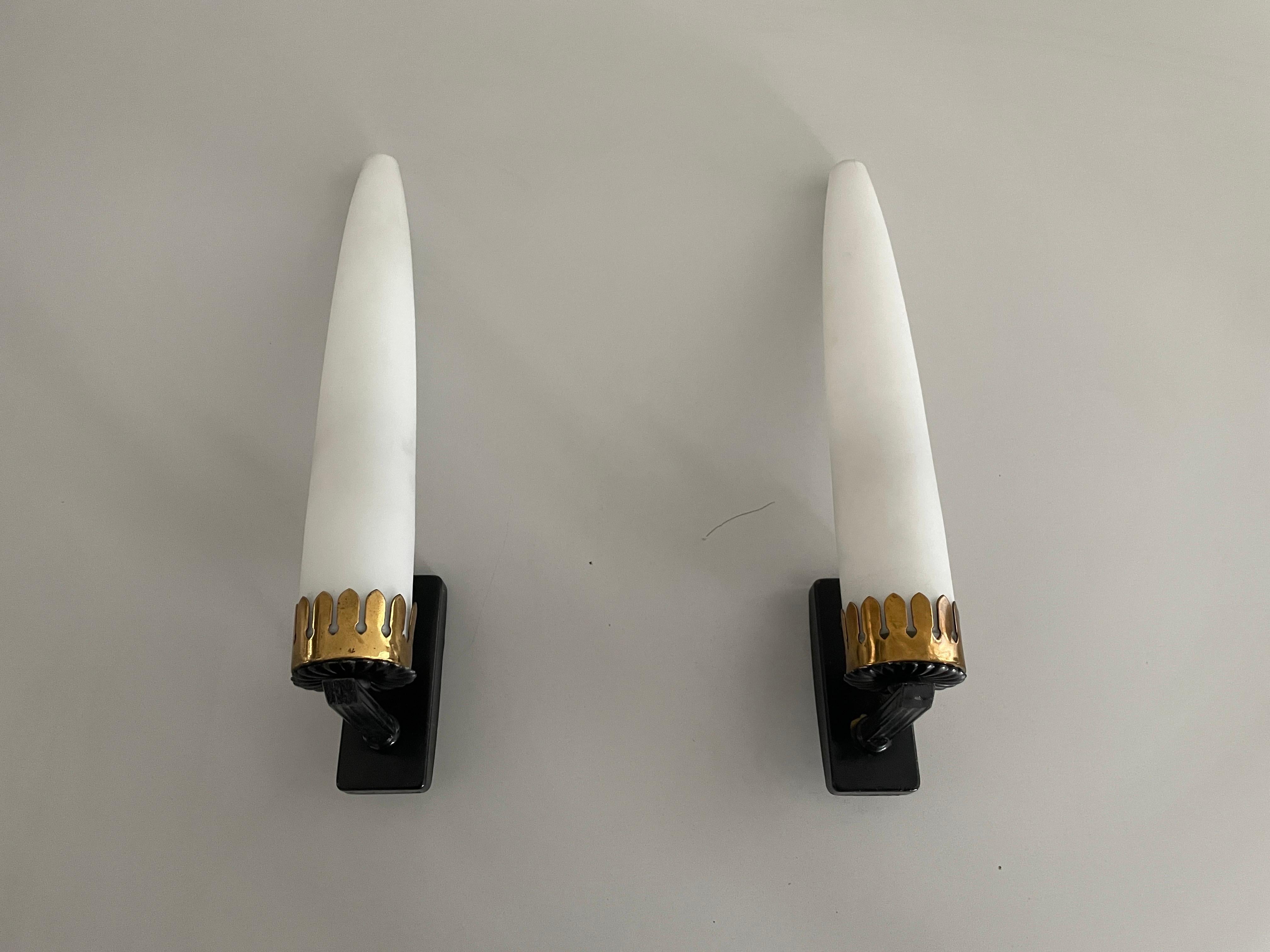Mid Century Modern Long White Glass Tubes Pair of Sconces, 1960s, Italy

Very elegant and minimal design wall lamps
Lamp is in very good condition.

These lamps works with E14 standard light bulbs. 
Wired and suitable to use in all countries.