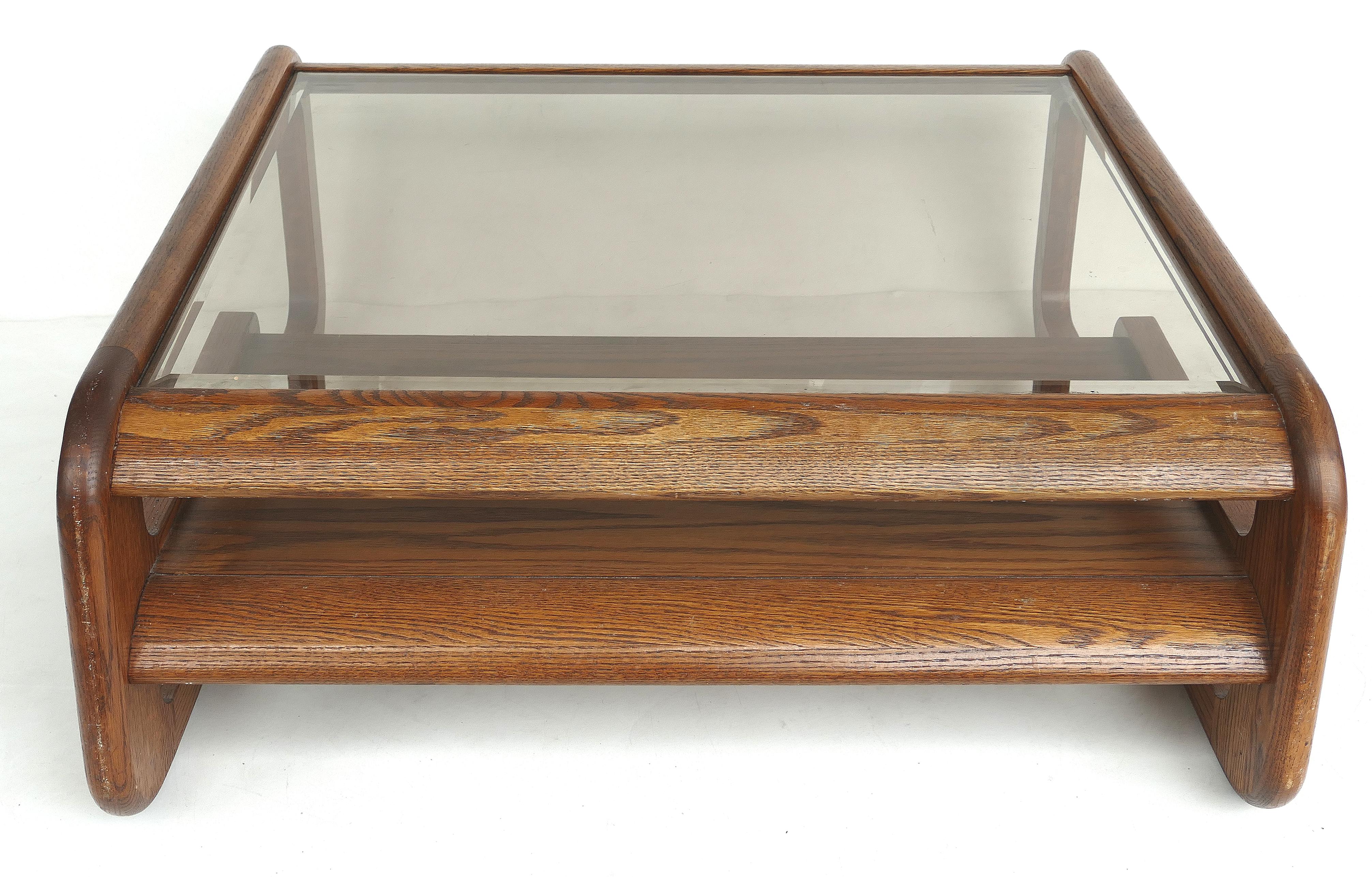 Mid-Century Modern Lou Hodges coffee table, California design

Offered for sale is a California design Mid-Century Modern Lou Hodges (1937-2003) oak coffee table with an inset lightly smoked grey glass top with beveled edges. The table also has a