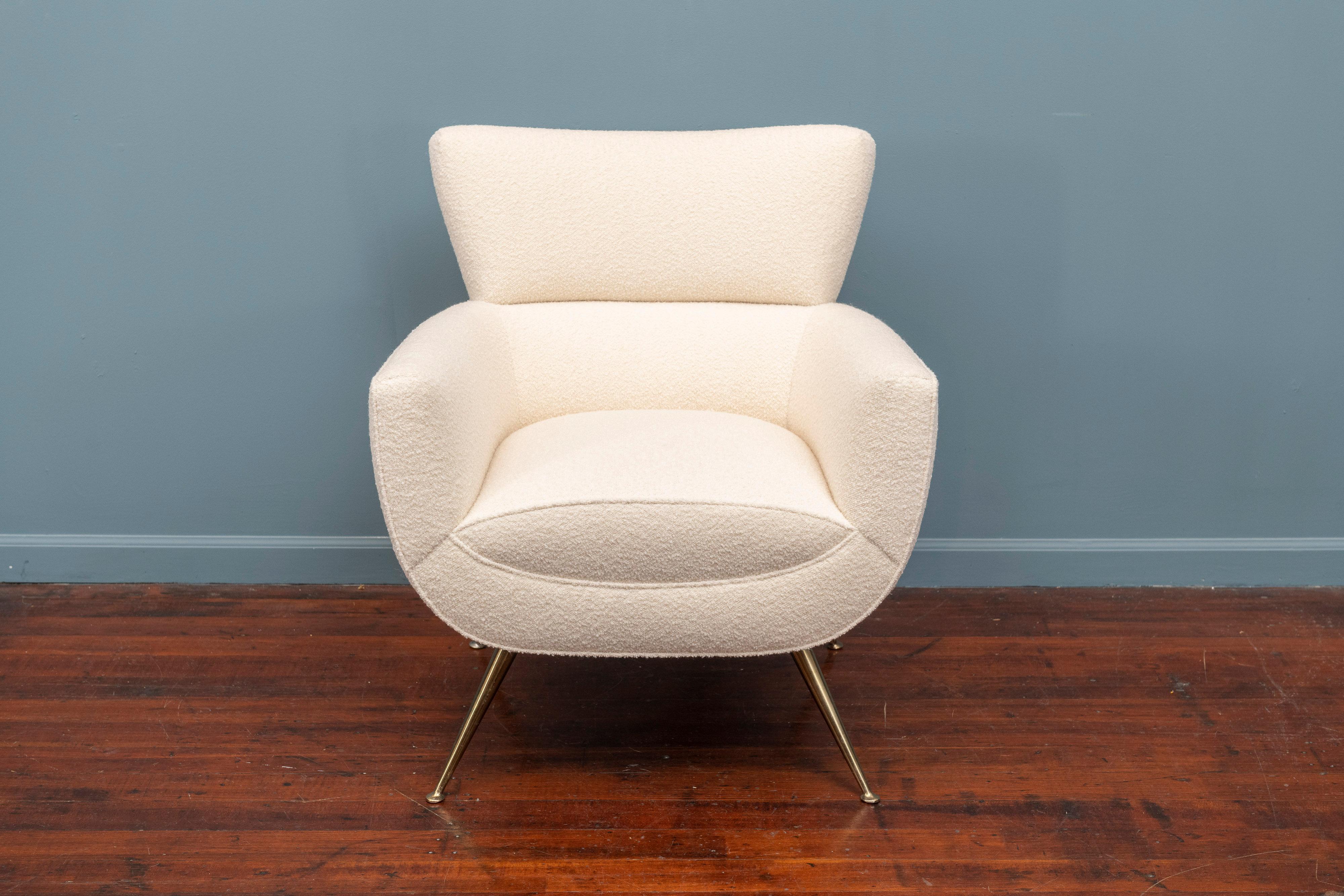 Mid-Century Modern lounge chair by Henry Glass, newly upholstered in cream bouclé fabric on tapering brass legs.