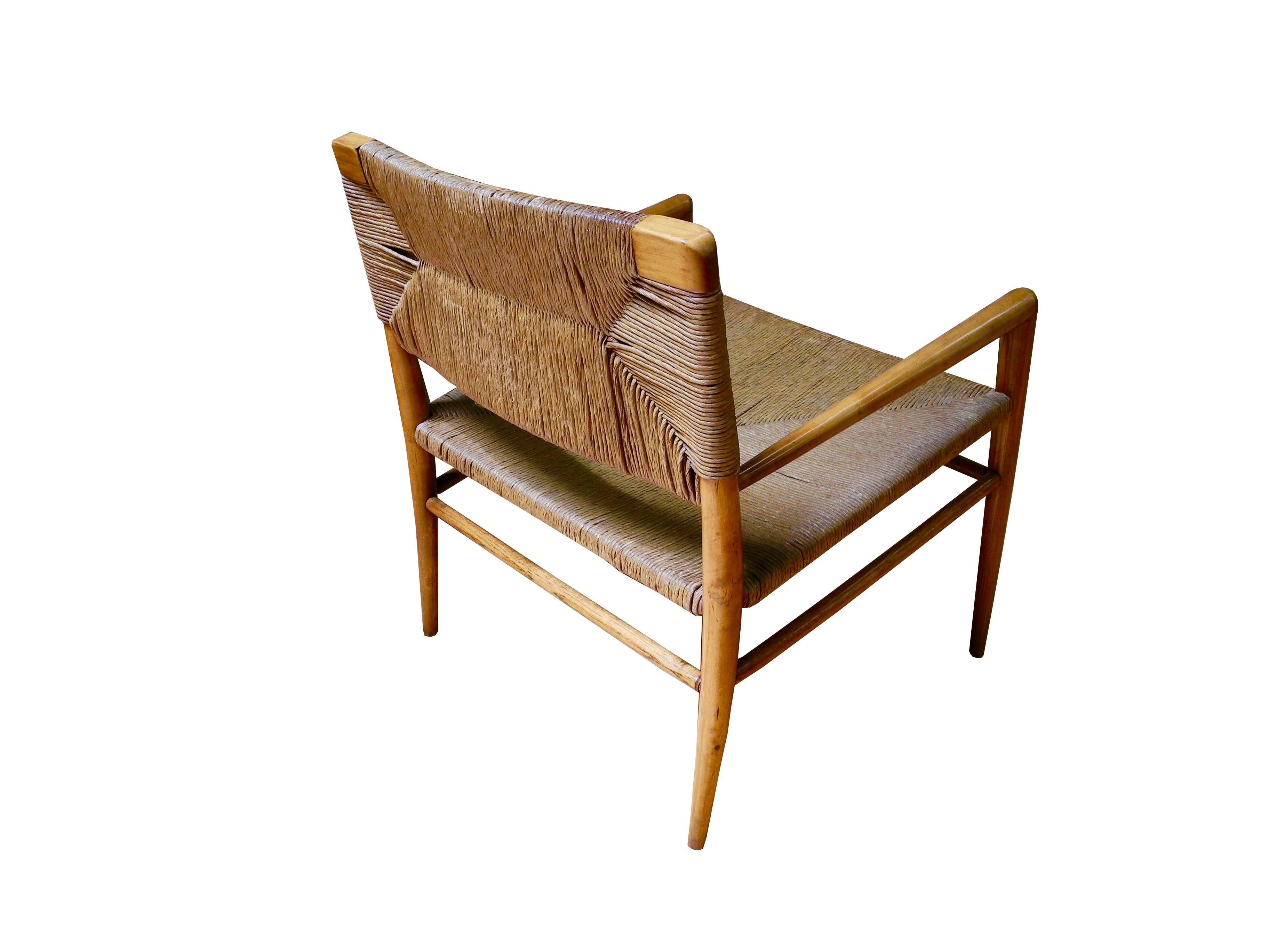 This vintage, comfortable, single, lounge chair by Mel Smilow is made of walnut and handwoven rush.