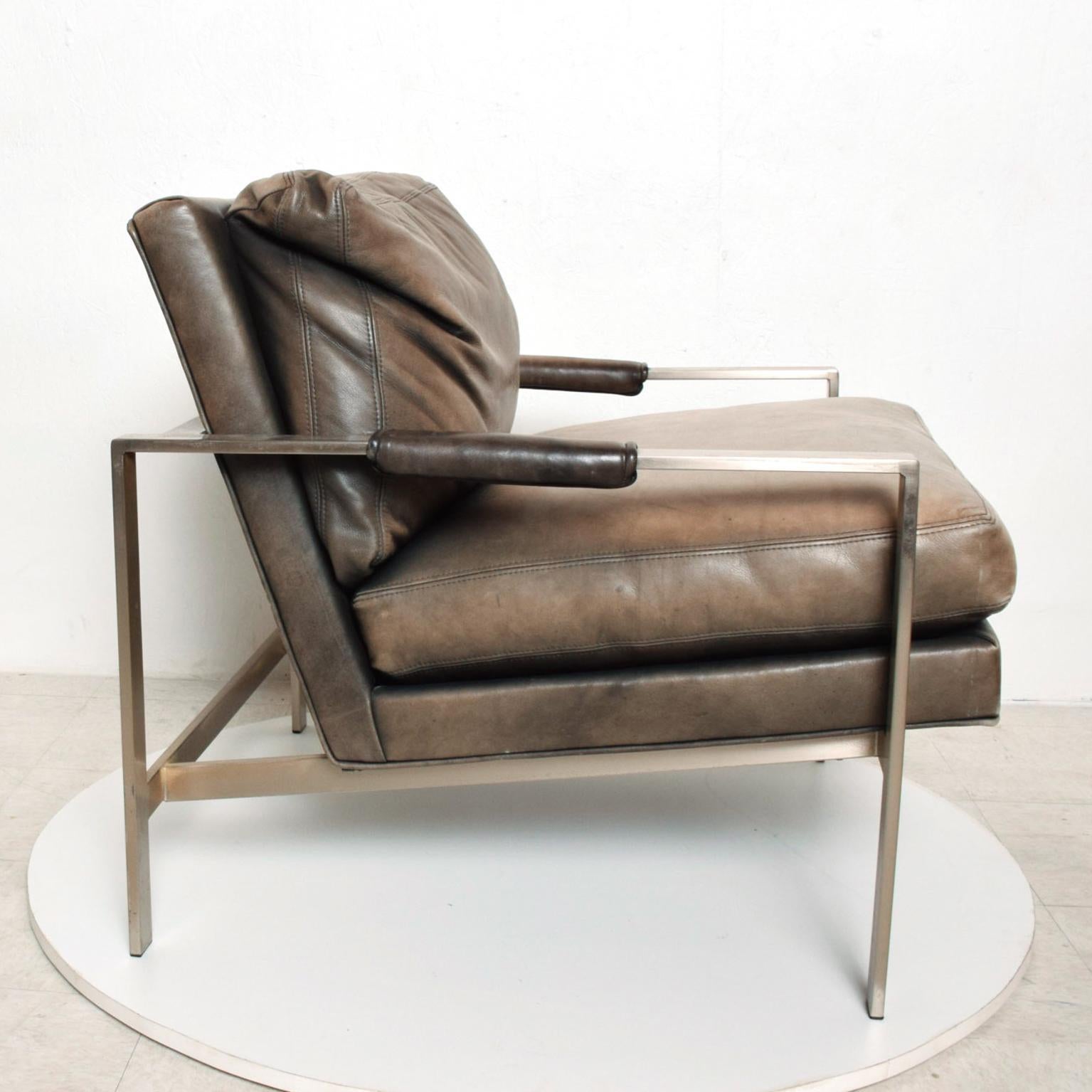 We are pleased to offer for your consideration a mid-century armchair designed by Milo Baughman for Thayer Coggin. Nickel-plated steel with original leather upholstery. The chair retains label from the maker.

Dimensions: 32