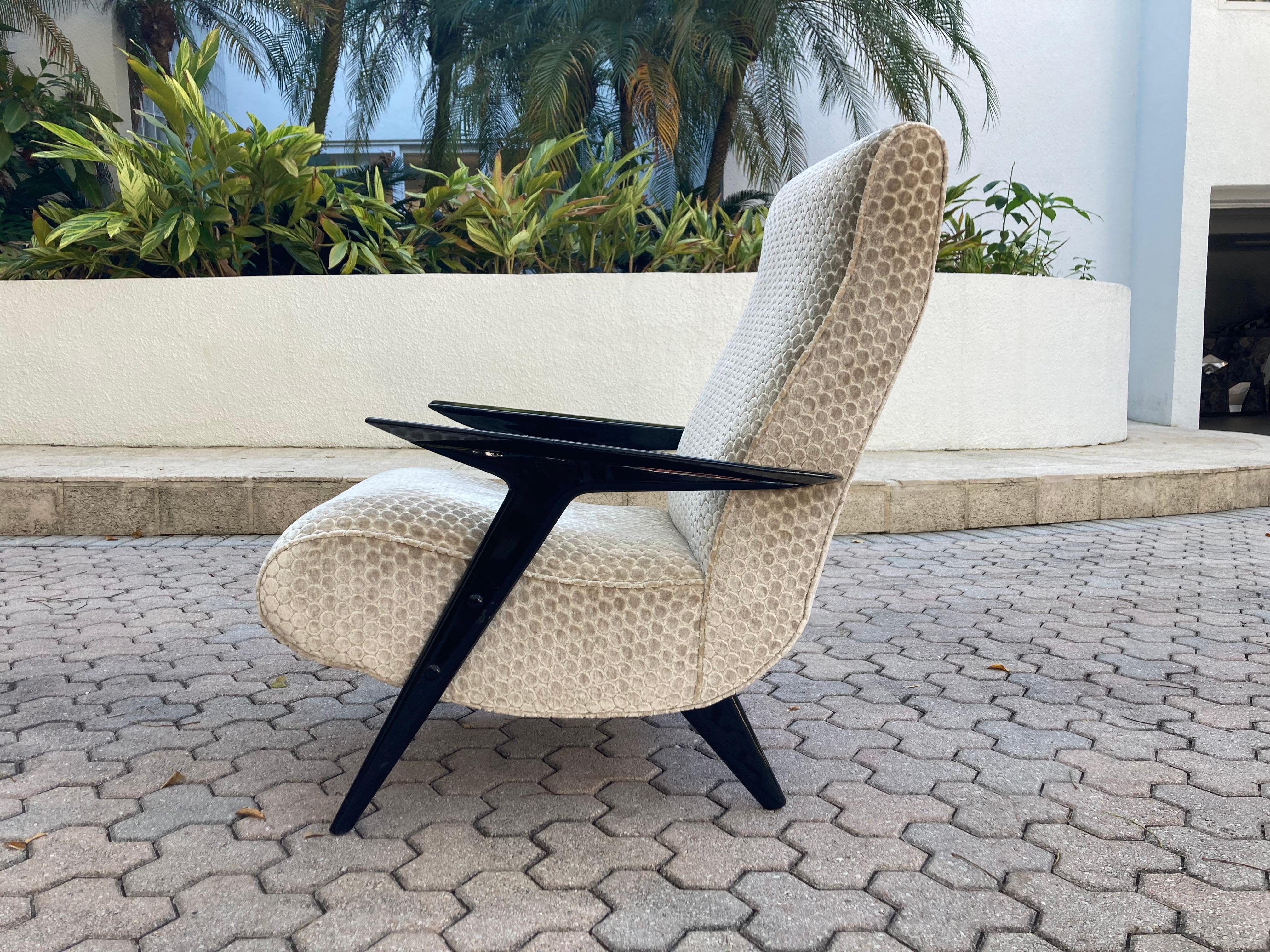 Italian lounge chair from the 1960s, black painted wood and arms and legs and fabric covered seat and back.