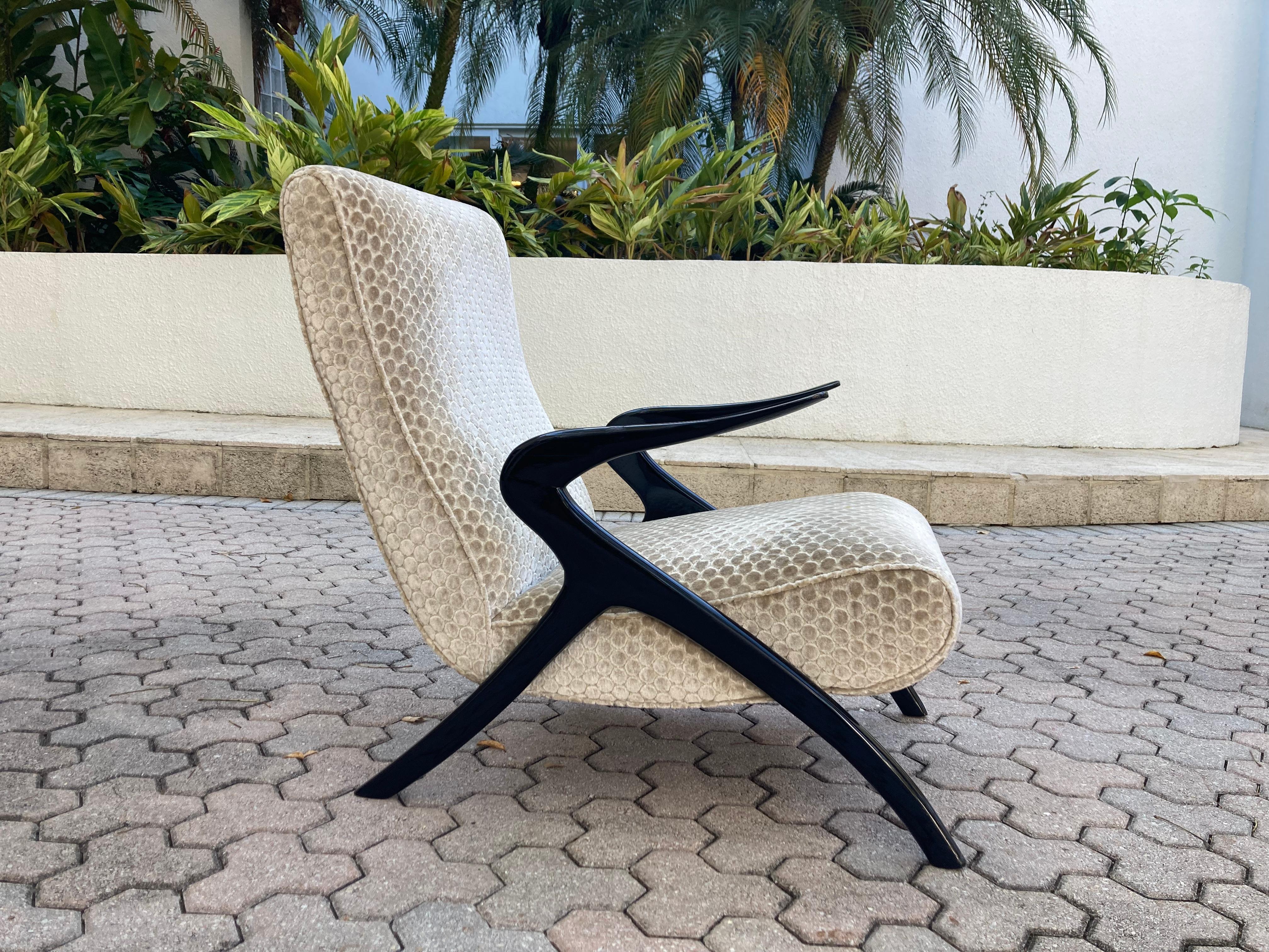 Italian Mid-Century Modern lounge chair, black painted wood and fabric covered seat and back.