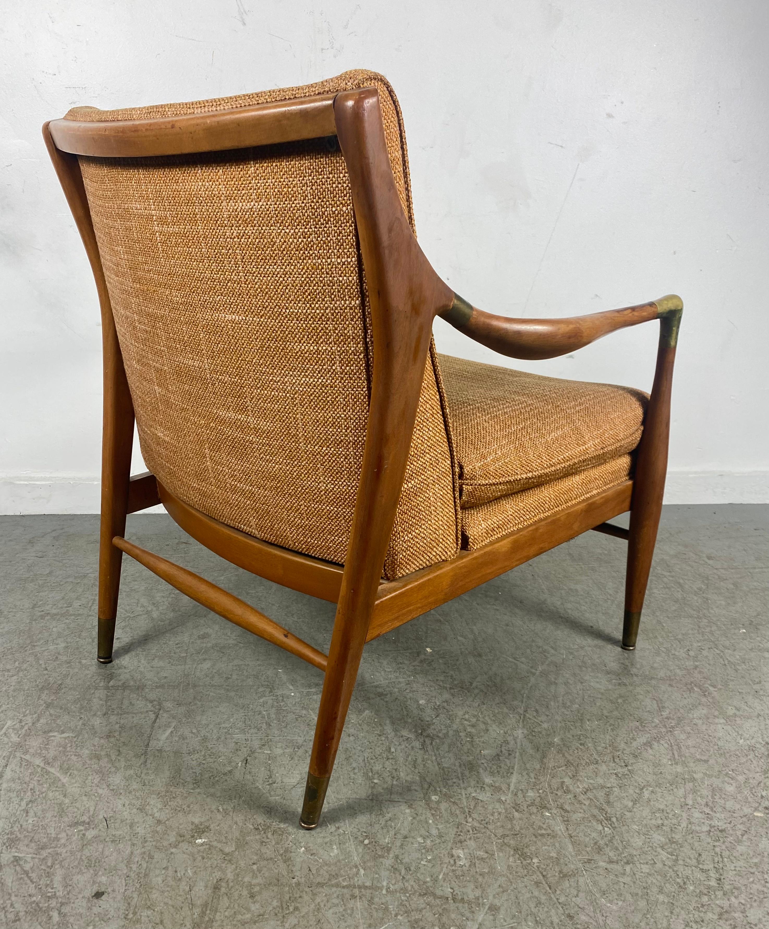 1950s Sculptural walnut armchair having solid brass armrest elbows and brass sabots by Jamestown Royal. Amazing quality and construction,, Retains original upholstery,, Extremely comfortable,, Wonderful design,, Hand delivery avail to New York City