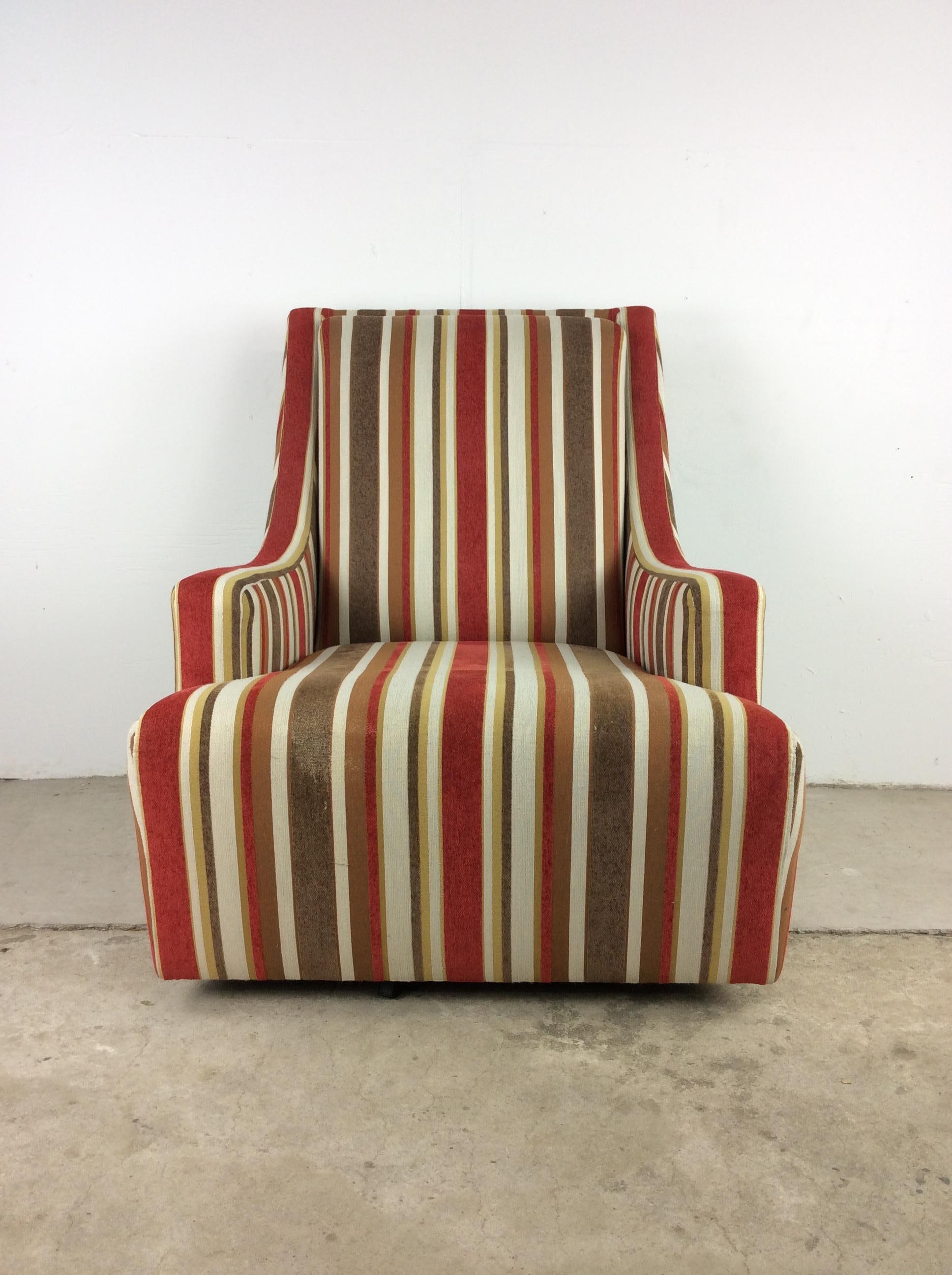 This mid century modern lounge chair features vintage striped upholstery, removable cushion, and swivel base. 

Pair of cane back arm chairs with matching upholstery available separately.

Dimensions: 30.5w 33d 36h 21ah 16sh

Condition: The striped