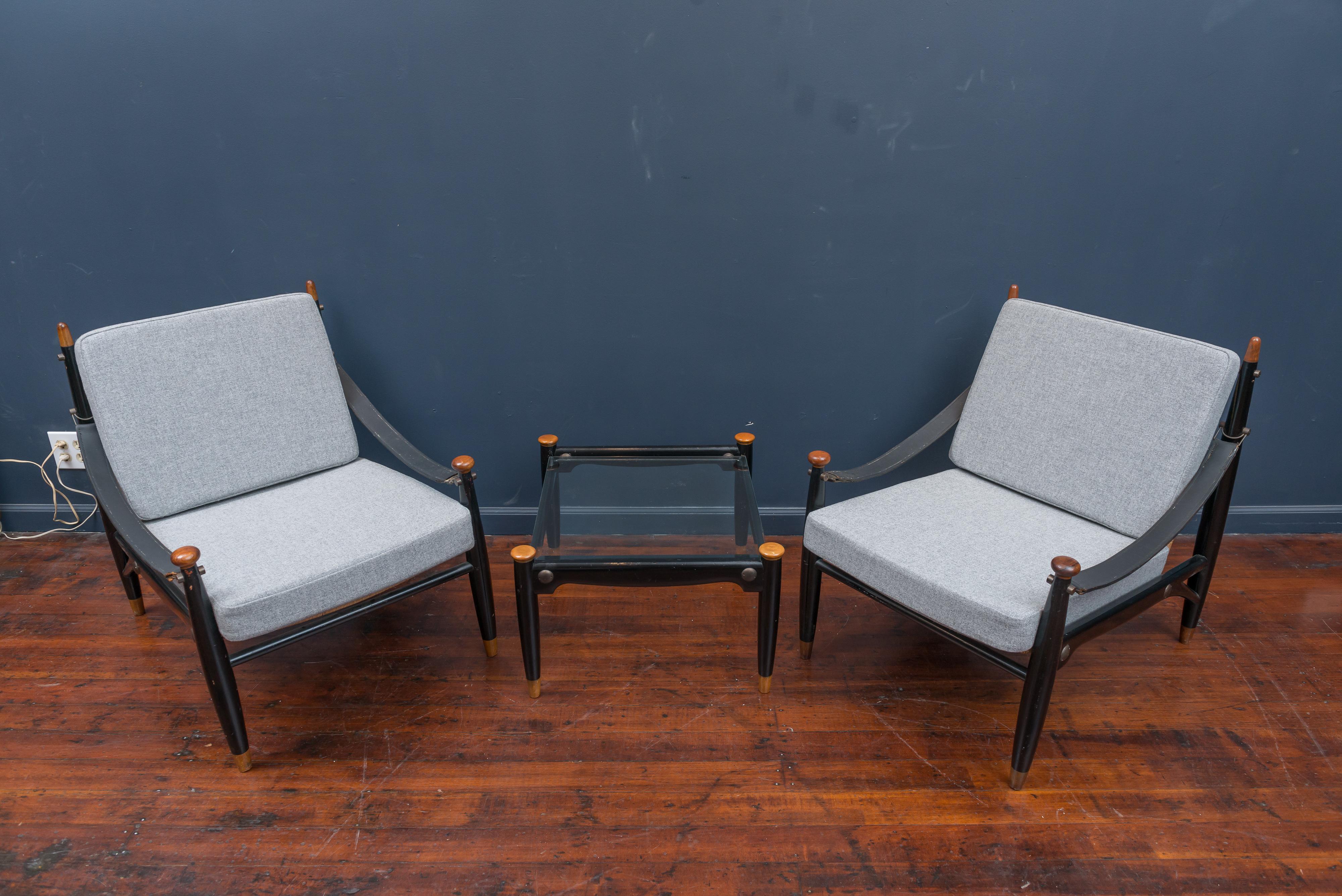 Pair of Mid-Century Modern lounge chairs and matching drinks table. Newly made cushions and upholstered in Danish wool. Chairs are in good condition without any breaks in the cane frames, possibly of Japanese origin.