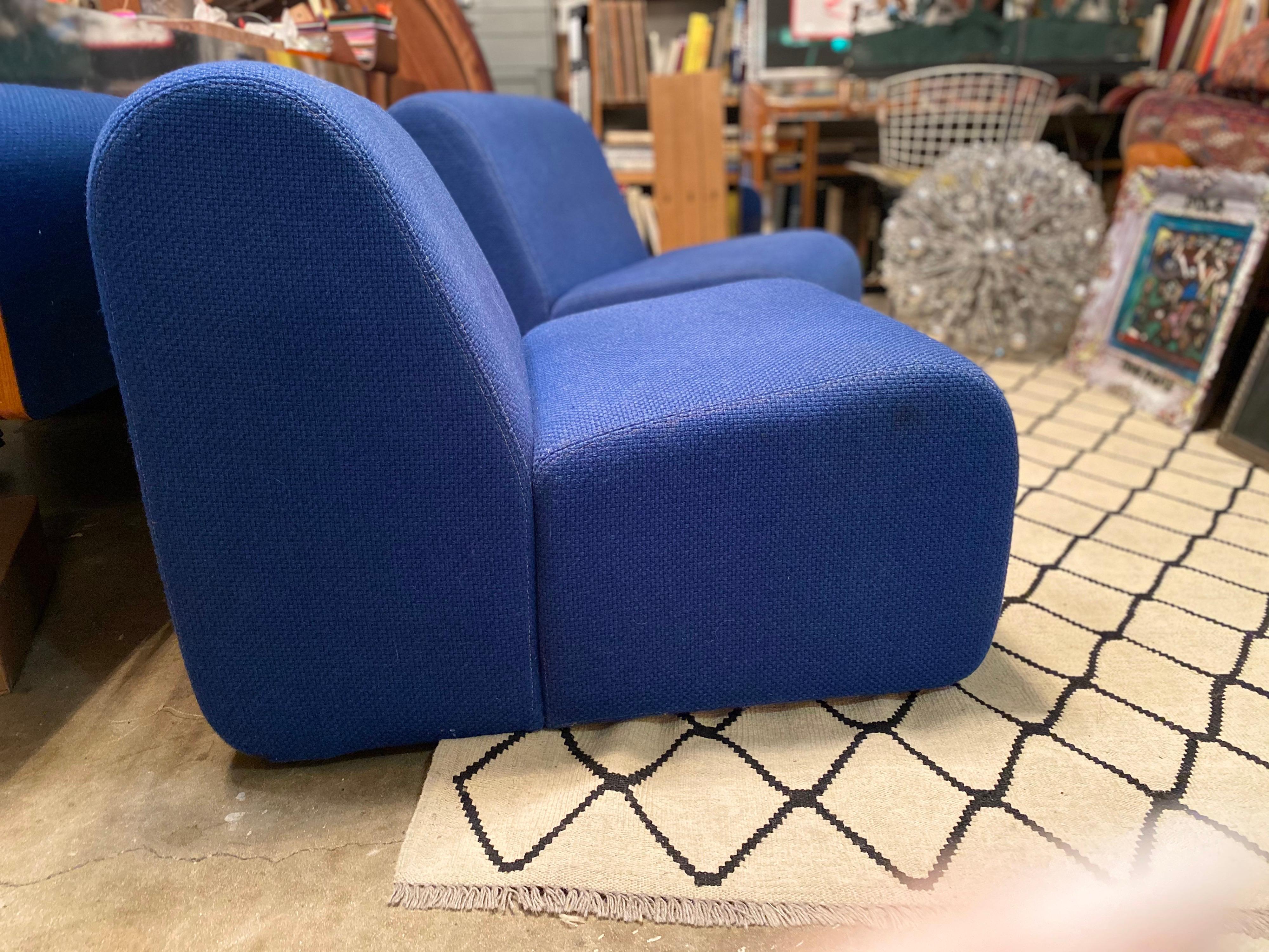 Mid-Century Modern designed by John Mascheroni features blue fabric and a low seat. These mid-century lounge chairs are in good overall vintage condition.
