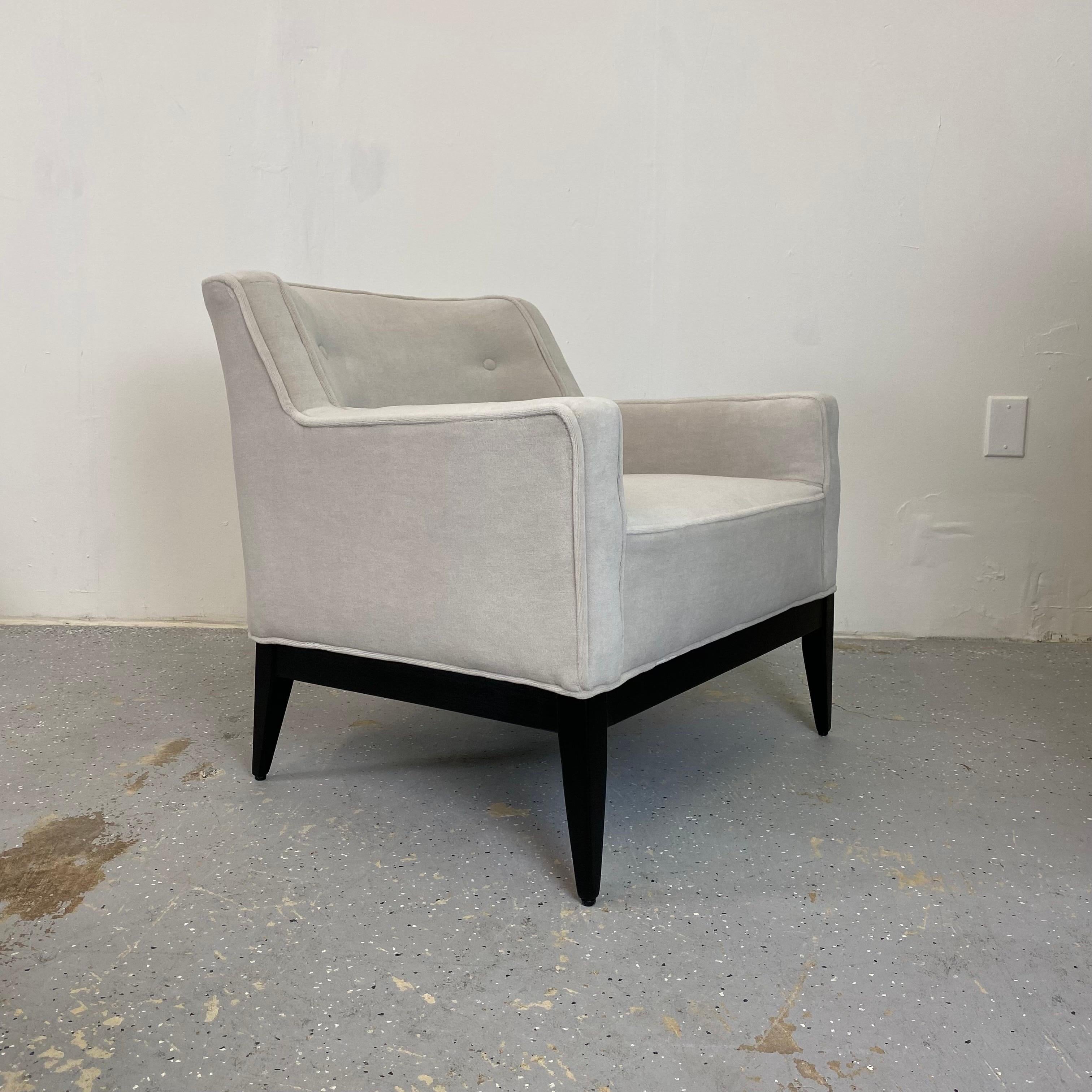 Low profile and extremely comfortable pair of Jens Risom style lounge chairs. Soft velvet upholstery with contrasting black wood frame.