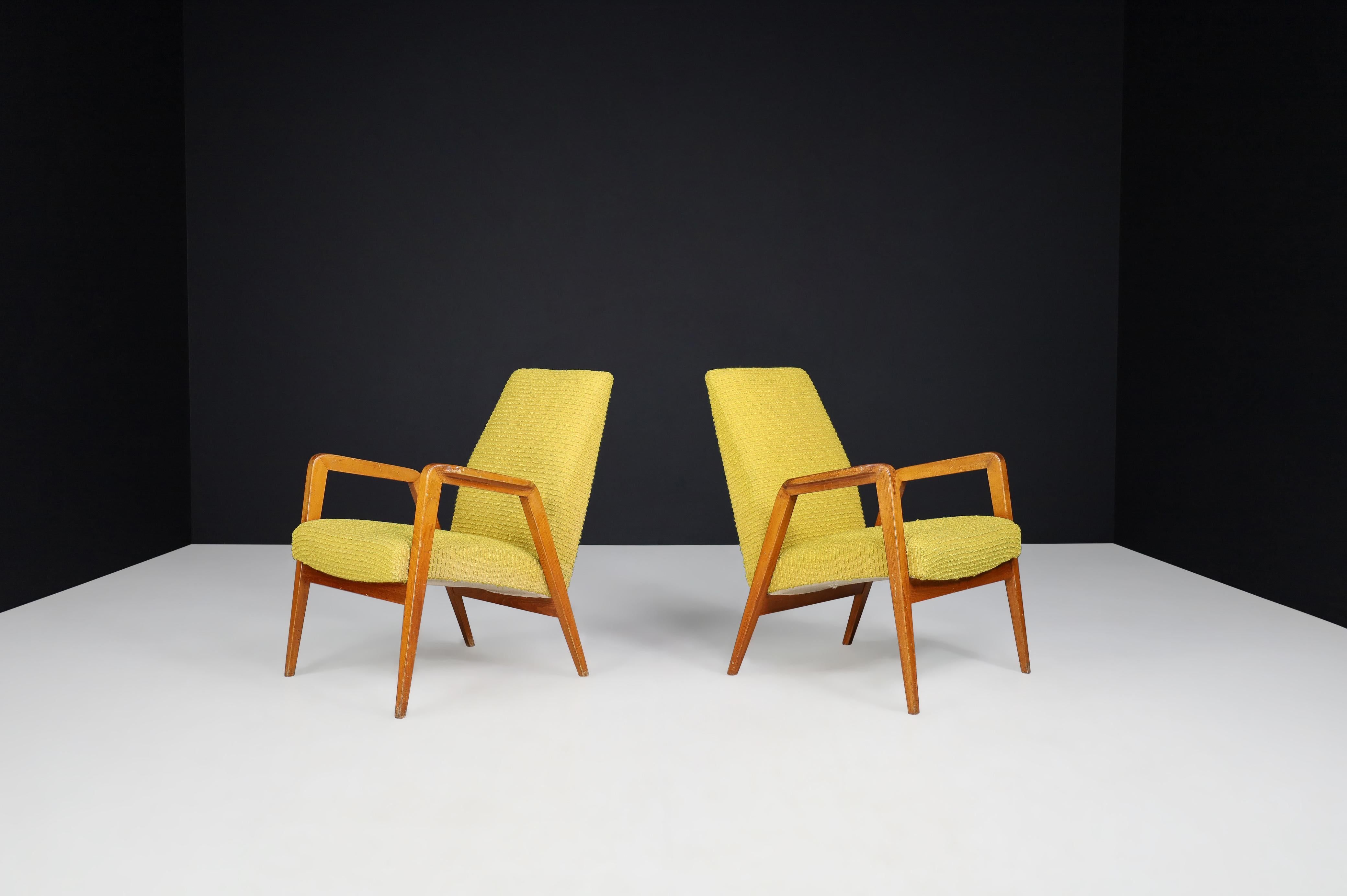 Mid-Century Modern lounge chairs in original lemon upholstery, Praque 1950s 

Mid-Century Modern lounge chairs original lemon upholstery manufactured and designed in Praque 1950s. Their fine lines, armrests, and seating give these armchairs a