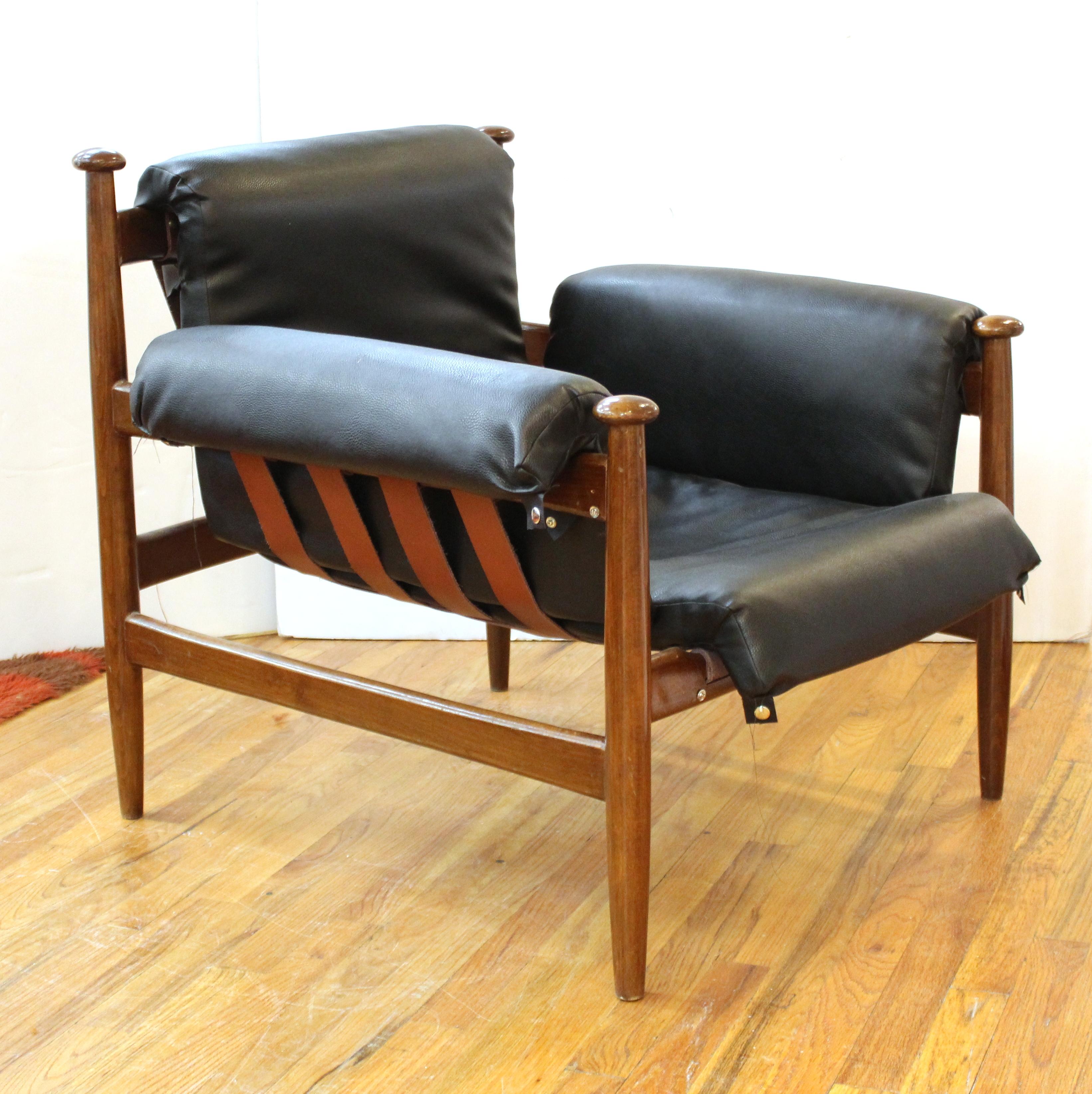 Mid-Century Modern pair of wooden frame lounge chairs or armchairs. The pair has leather upholstery. In great vintage condition with age-appropriate wear and use.