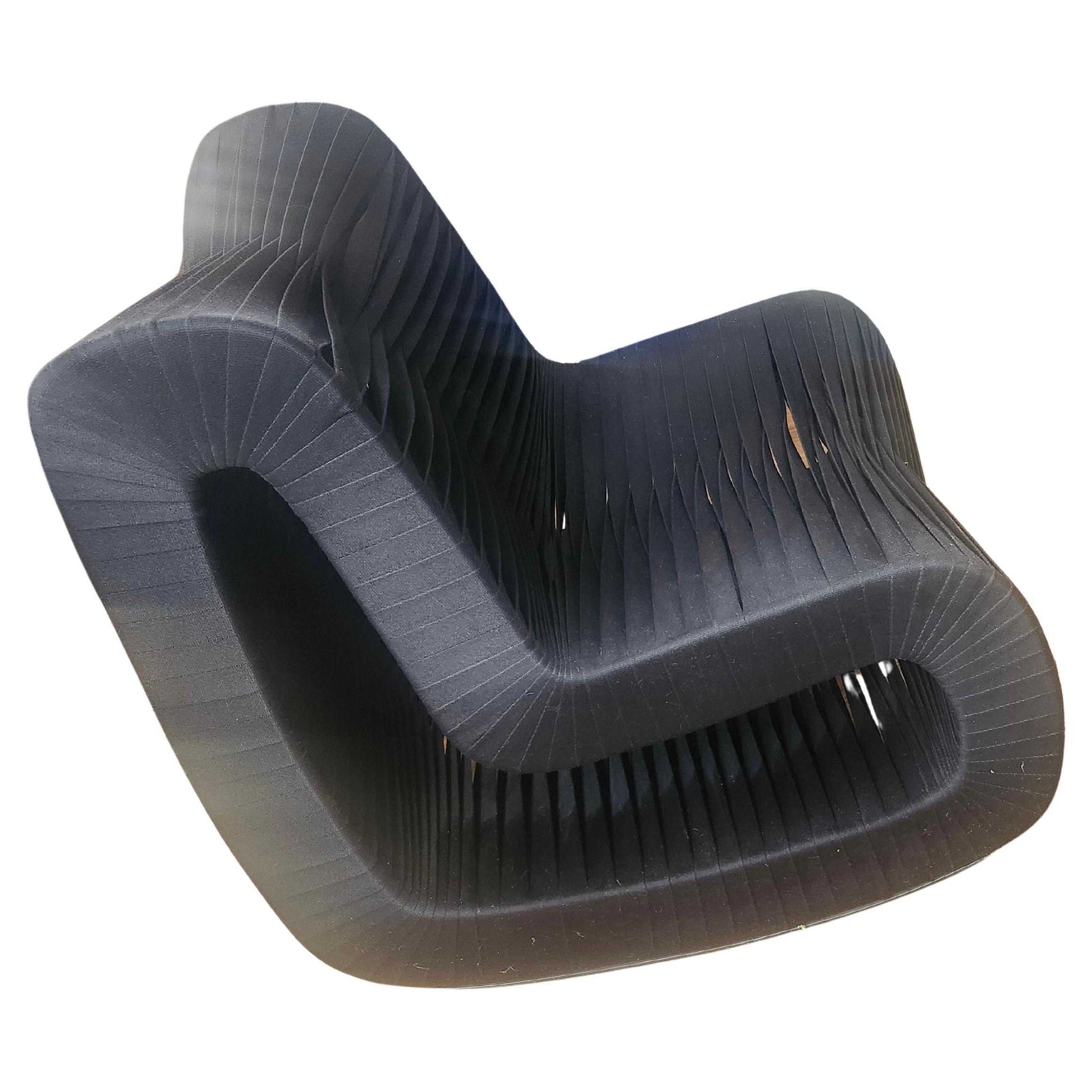 Rare and fabulous pair of lounge chair rockers from the Phillips Collection.  Designed by Nuttapong Charoenkitivarakorn
who was inspired when visiting a seat belt fabric factory. Braided and interwoven black nylon tightly wound but flexible enough
