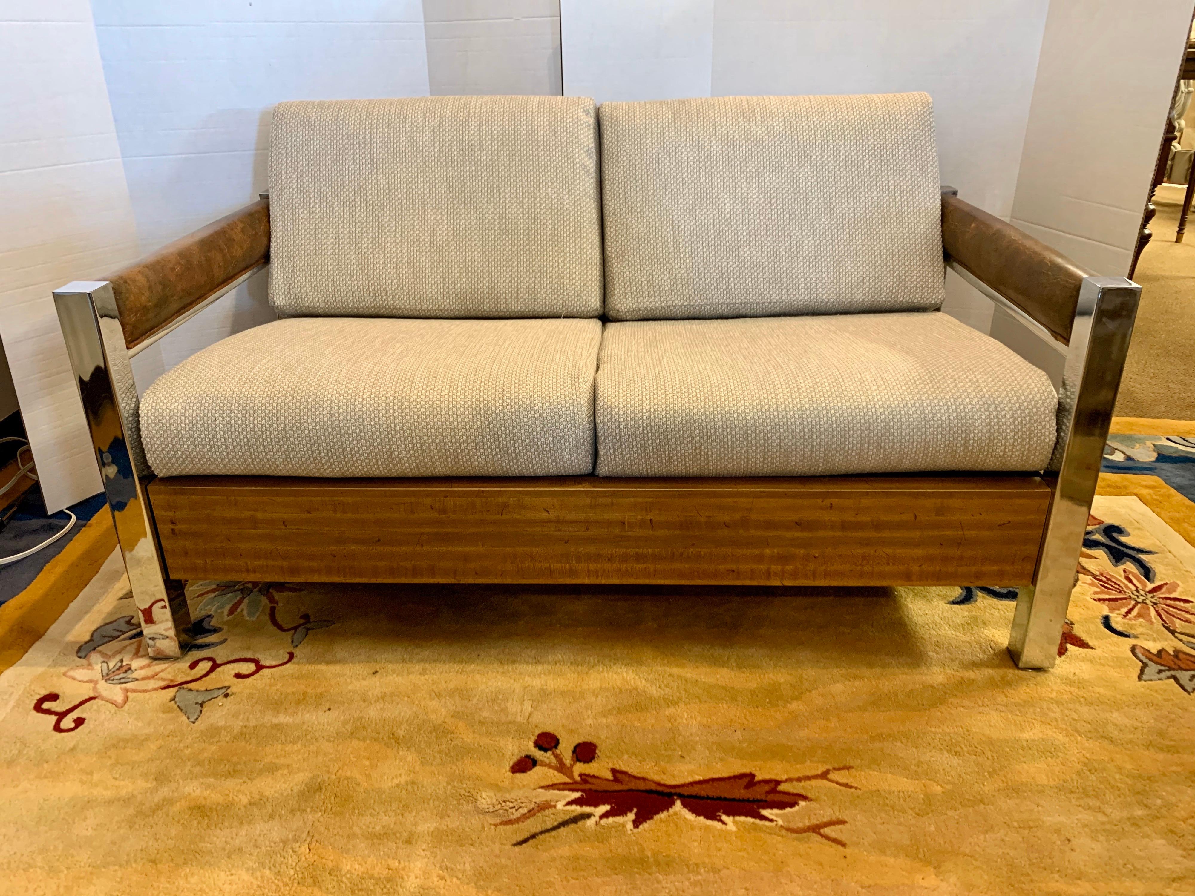 Made in the United States in the 1970s, this Milo Baughman style lounge loveseat has newer neutral upholstery and great lines.