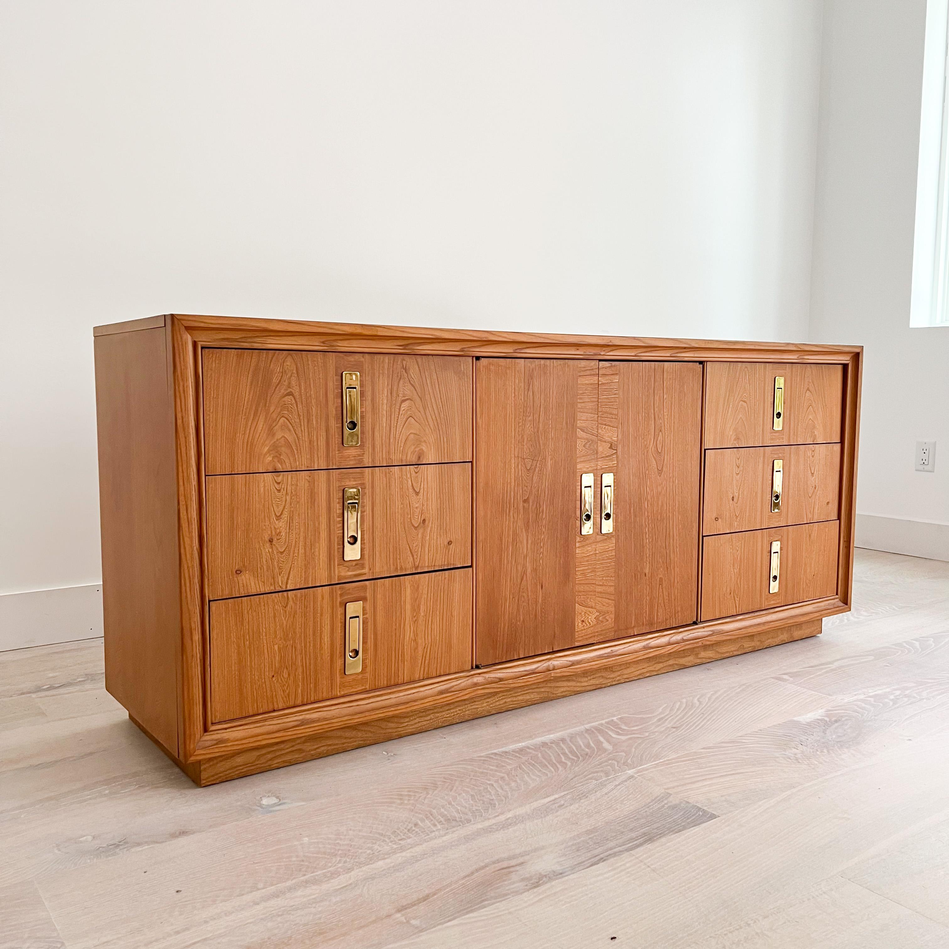 Rare mid century modern low dresser with brass drawer pulls by American Drew. 
American Drew's (a North Carolina company) portfolio of collections covers a broad variety of styles from modern to classical. Influenced by furniture craftsmen, and the