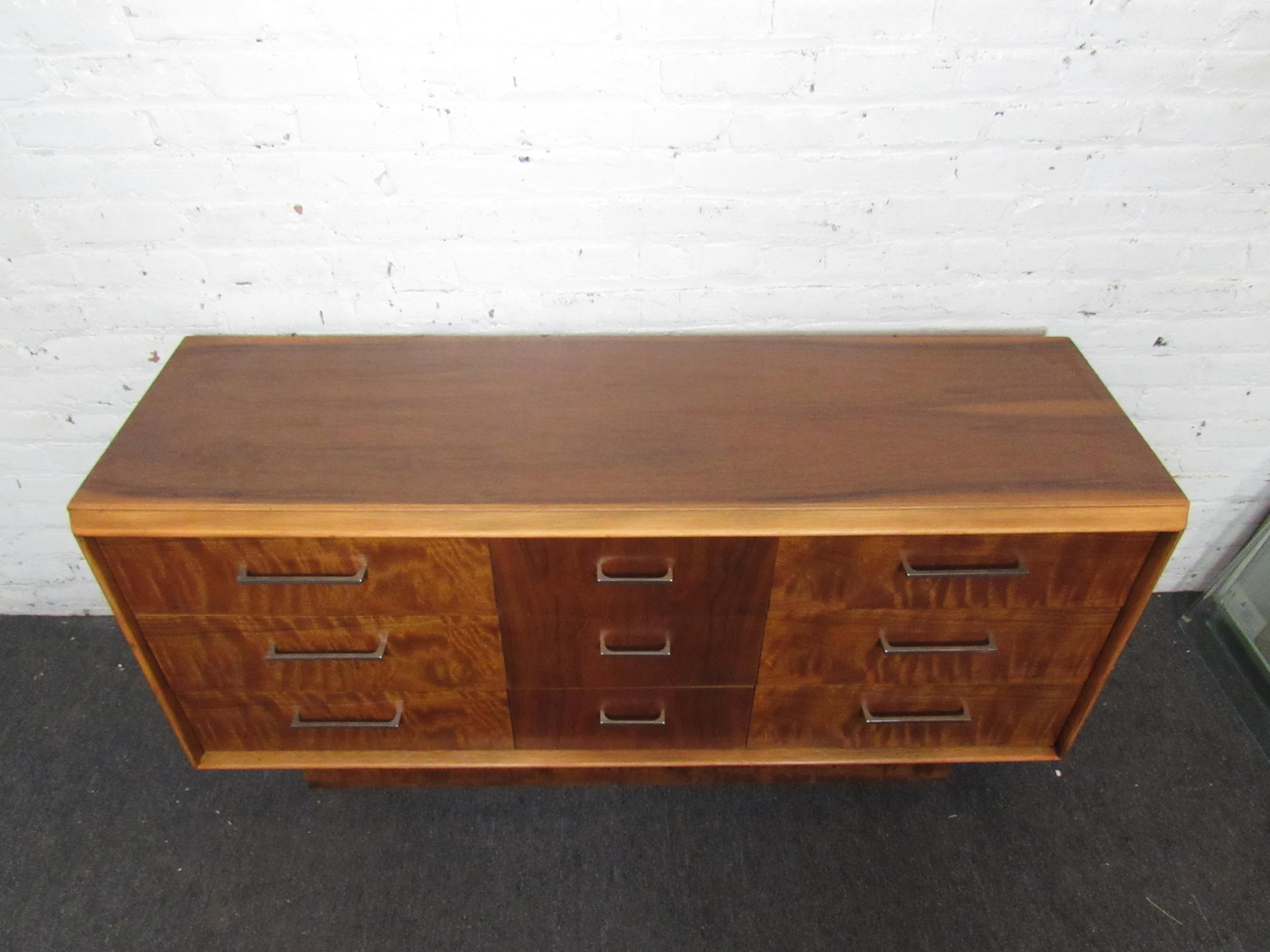 Full of Mid-Century style and craftsmanship, this vintage dresser by Lane is sure to be a lasting addition to any home or office. Contrasting walnut woodgrain on the dresser's front adds a unique look, while metal pulls complete the look. Please