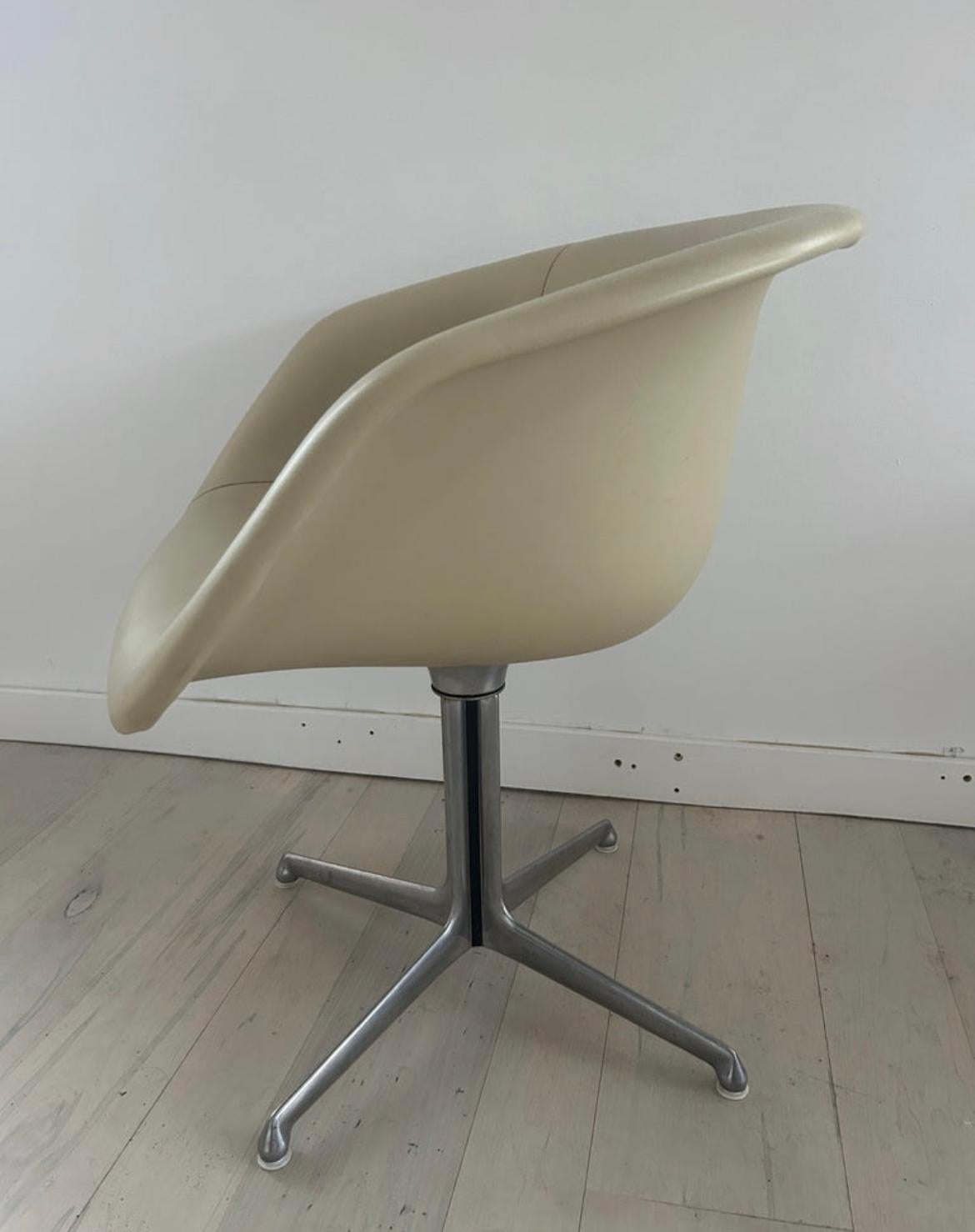 Mid-Century Modern Low Shell Dining chairs. Very clean low fiberglass shell Home or Office chairs with tan Naugahyde upholstery and sit on Aluminum swivel bases. Very Clean and sturdy all chairs are Matching in color and condition. Bases have all