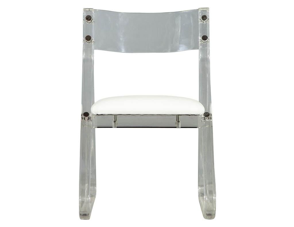 Vintage Lucite acrylic side chair with triangle base frame and slightly curved back. Upholstered seat and chrome button fittings on joints. Perfect for a desk or vanity setting.