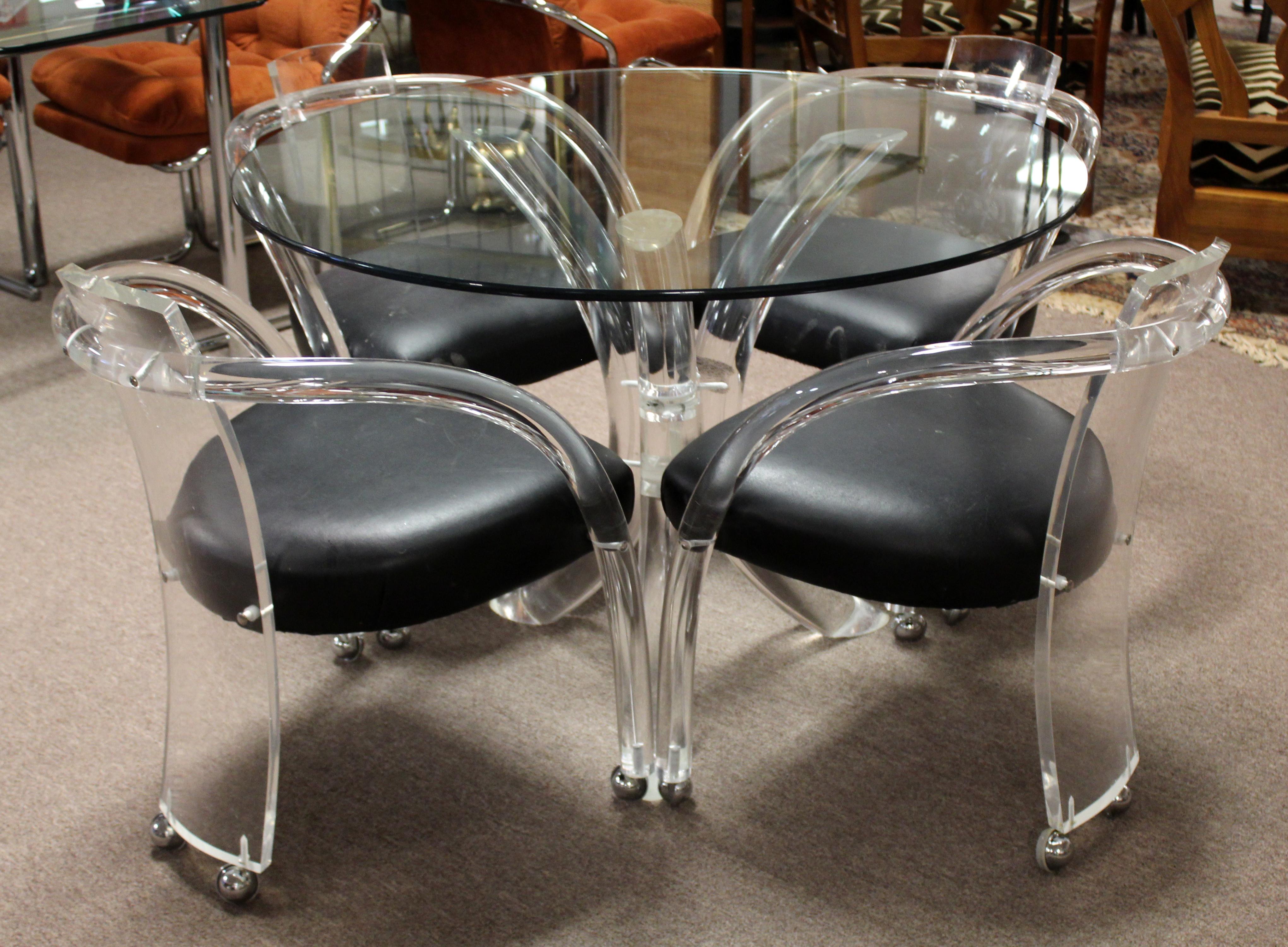 For your consideration is a luxurious looking dinette set, including four Lucite and vinyl armchairs, and a round table, made of Lucite and glass, by Charles Hollis Jones, circa 1970s. In vintage condition. The dimensions of the table are 42