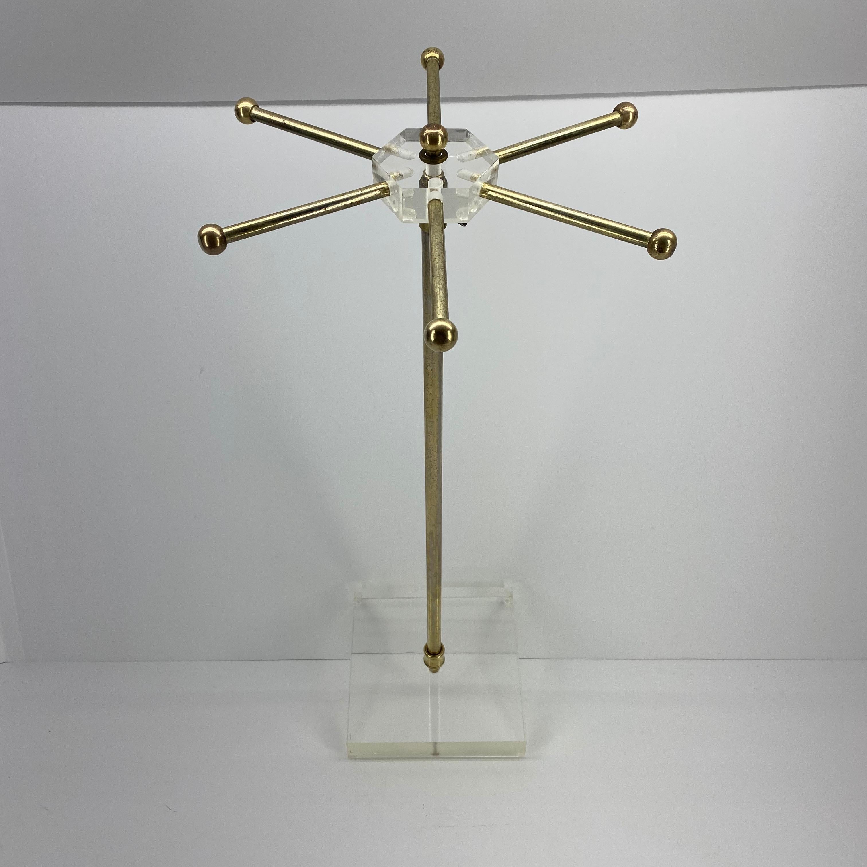 Mid-Century Modern Lucite tie and jewelry stand

This tie rack has a worn brass finish, please see attached images for details.

  