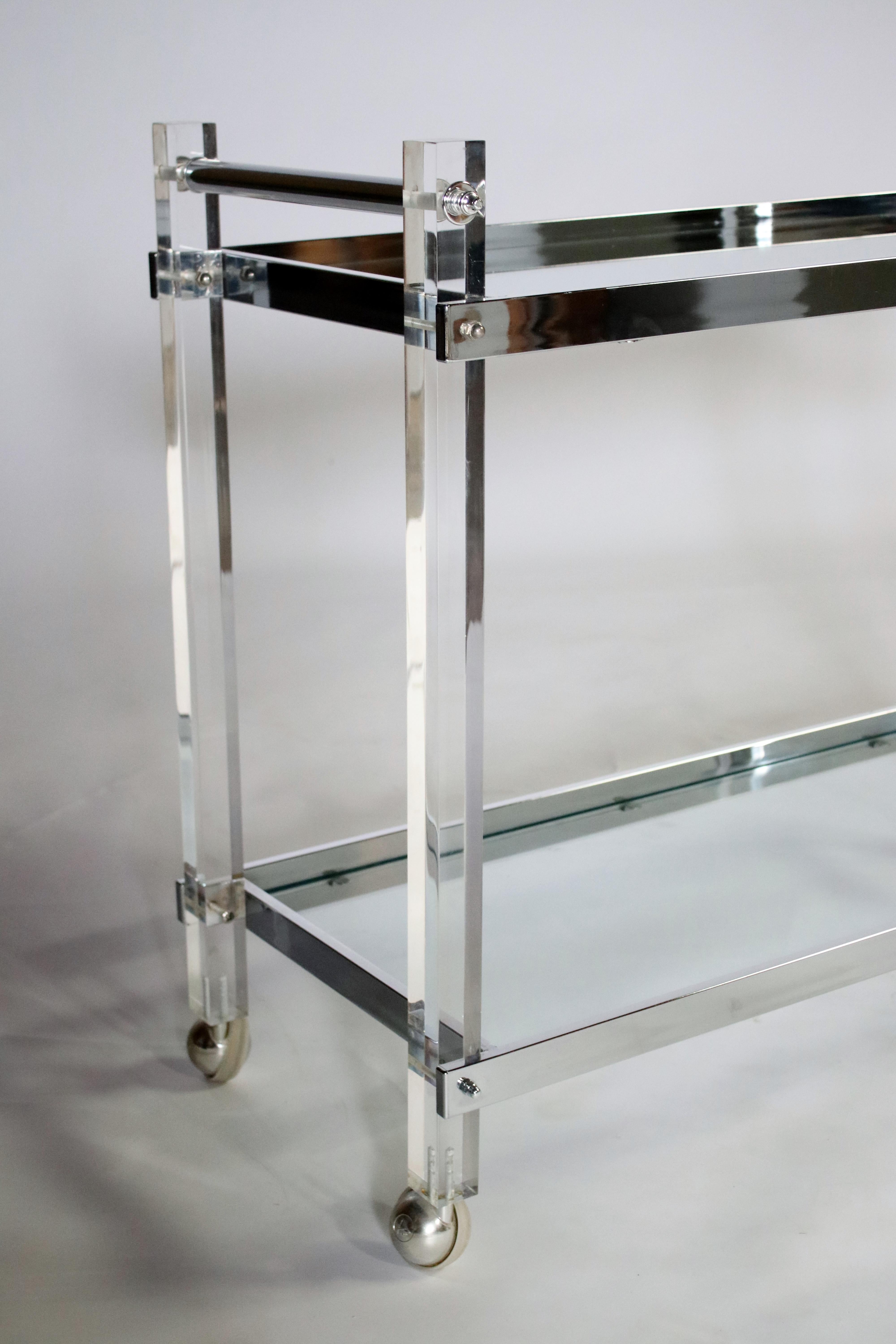 1970s chrome and glass and mirror rolling bar cart on castors.