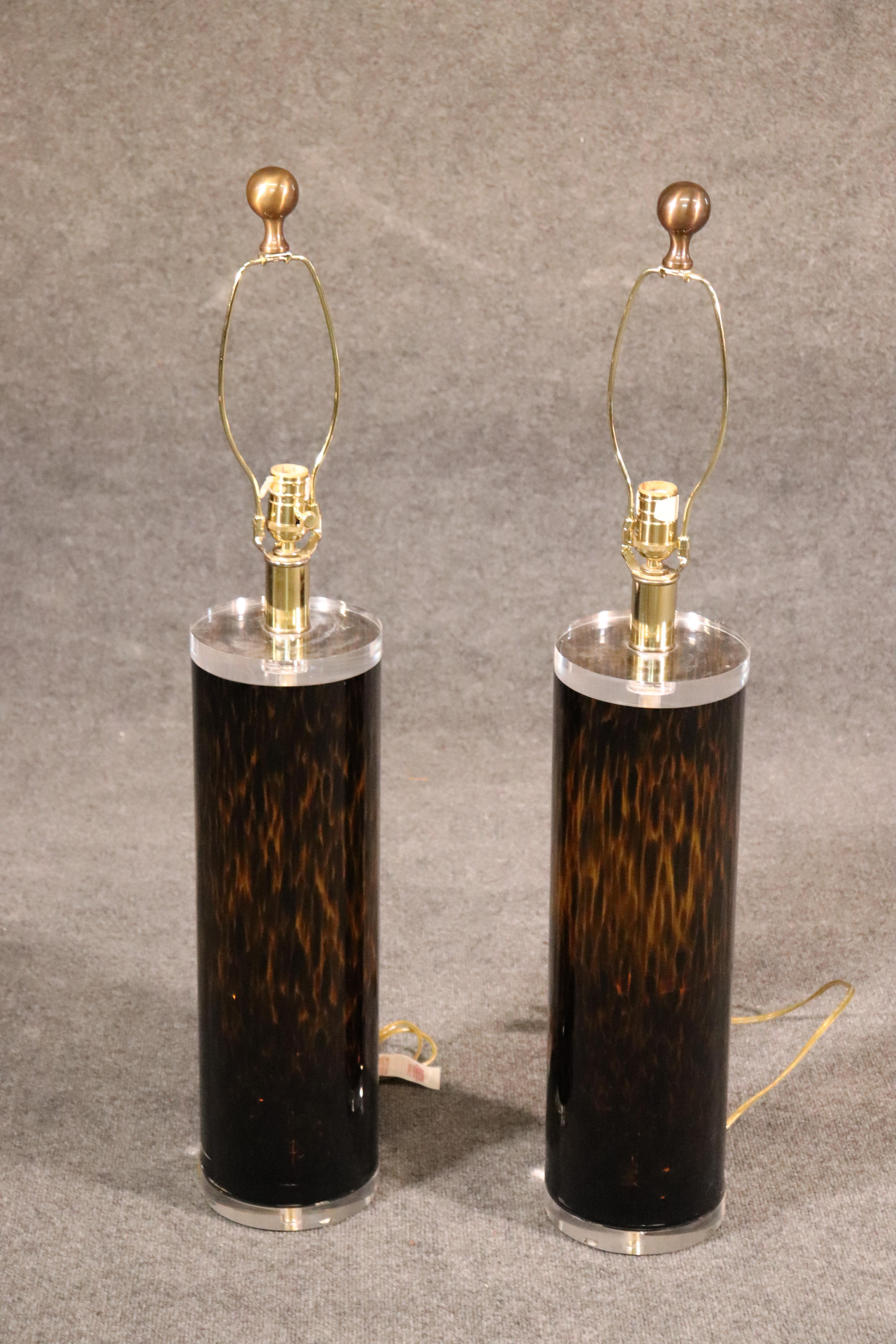 These are fantastic, heavy gorgeous Italian-made Lucite lamps. They are beautifully made to look like faux tortoise shell with Lucite tops and bases and solid brass finials. The table lamps are in superb condition and have minimal wear and signs of
