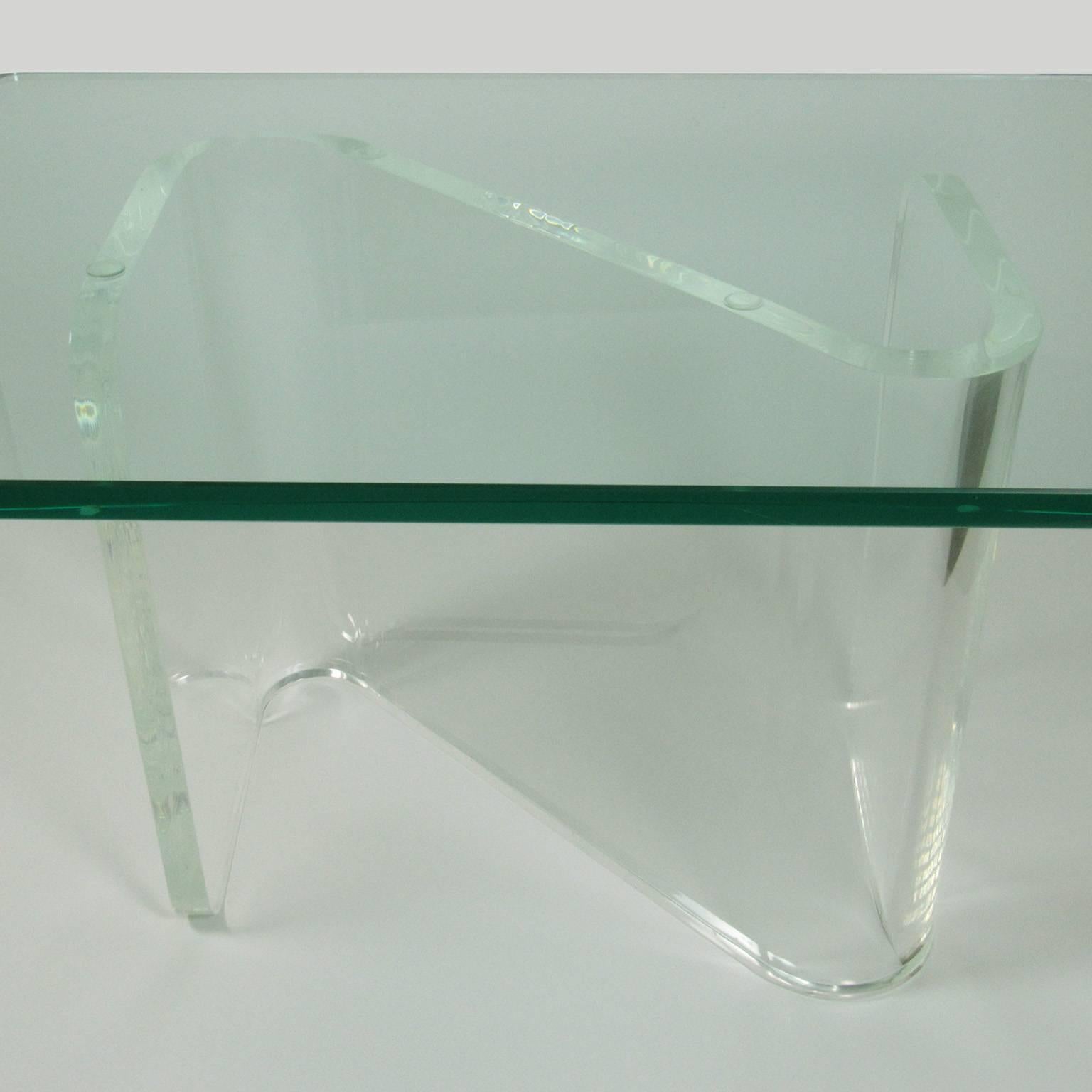 Mid-Century Modern Lucite and glass coffee table, with z-form Lucite base and rectangular glass top with rounded corners. Measures: Height: 16 3/4 inches, Top: 30 x 21 x 3/4 inches.