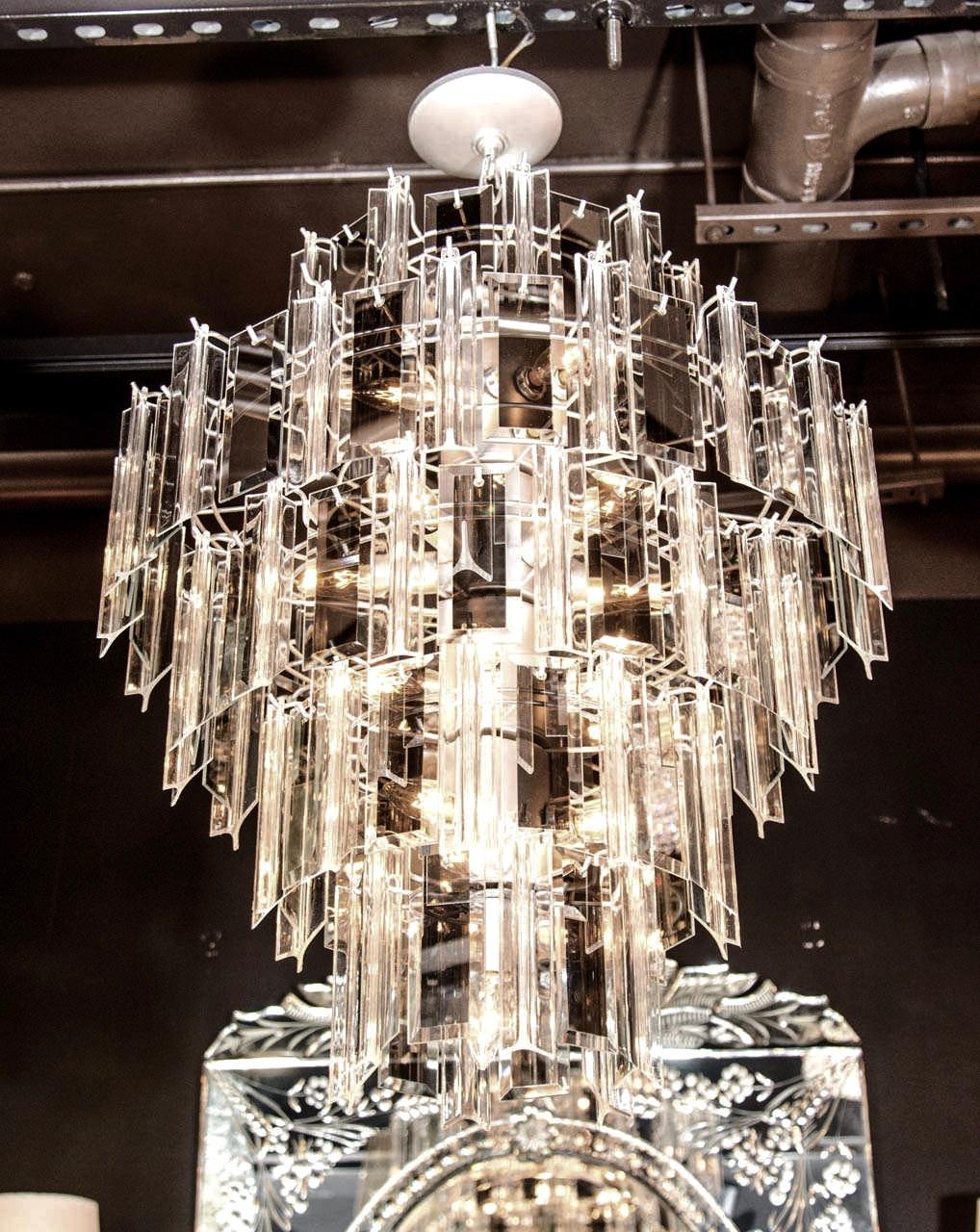 1970s five tier chandelier with alternating mirrored glass and Lucite prisms. Rectangular glass prisms have hand beveled borders with stunning smoked mirrored centers. Lucite triedre (three sided) prisms are beveled and have angled asymmetrical