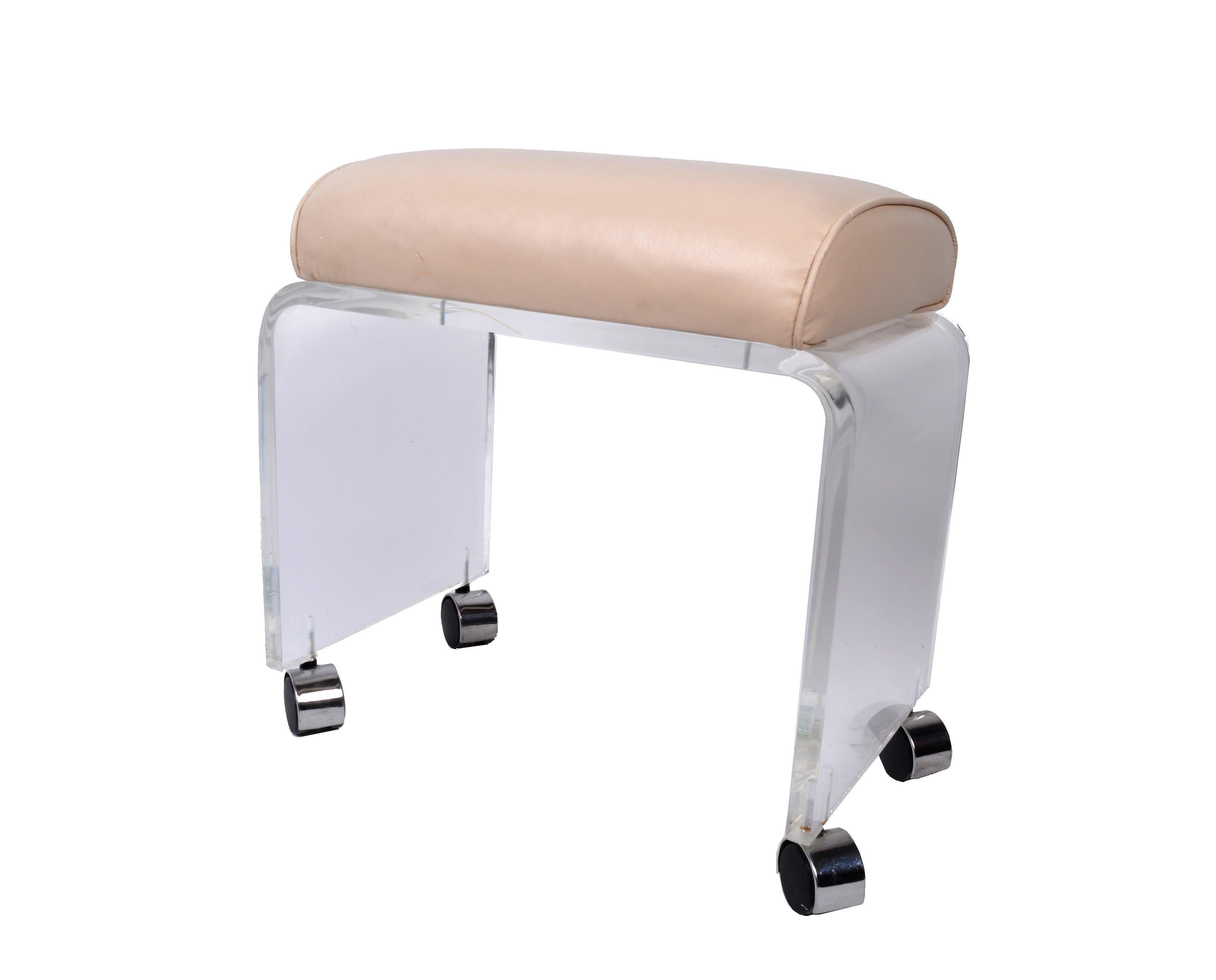 Classic Lucite stool on casters with a light brown vinyl upholstery.
Can be used as vanity stool or whatever you need it for.
Fits in with any design and decor, simply lovely.