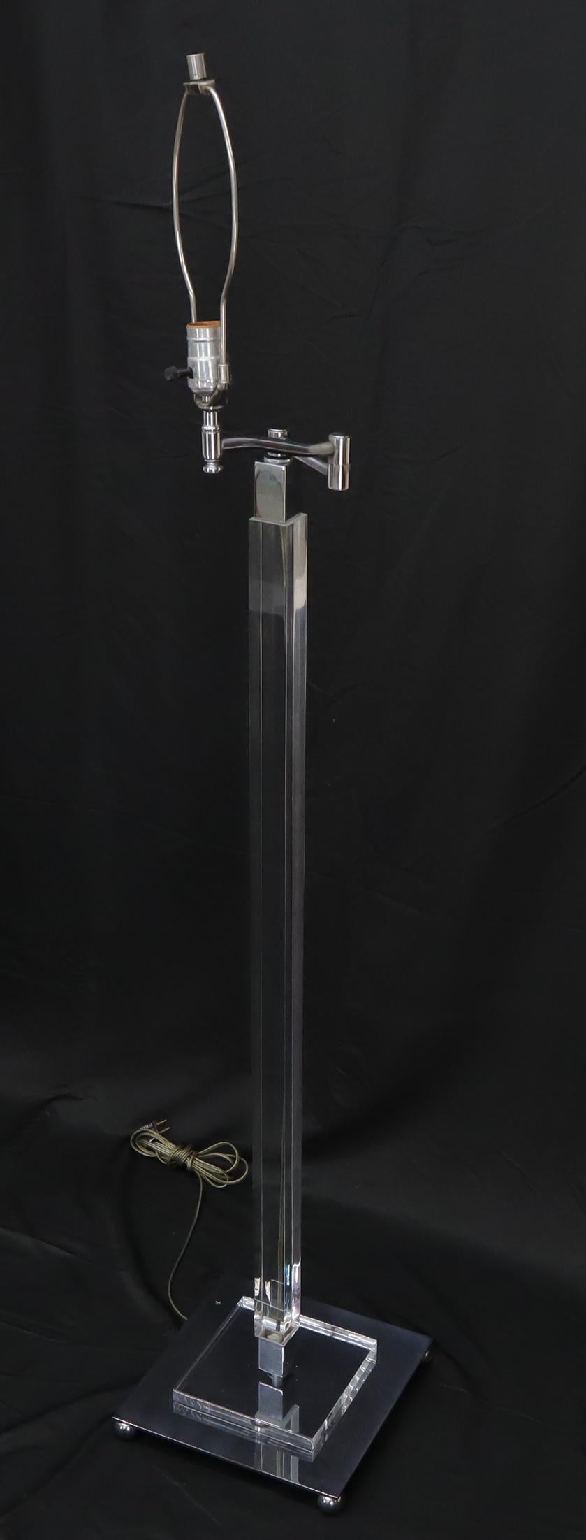 Mid-Century Modern Lucite and chrome base adjustable floor lamp.