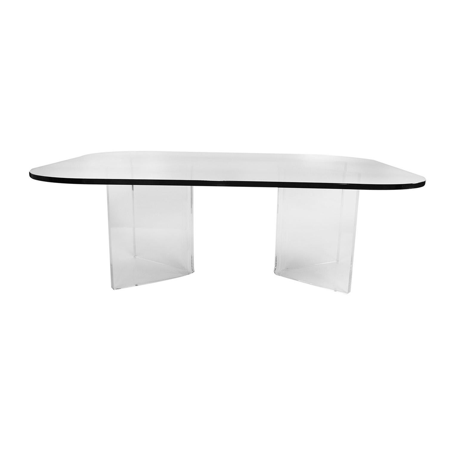 An elegant, stylish midcentury rectangular rounded corners glass top, with Lucite base coffee table. Features a unique two piece “V” shaped Lucite base supporting 1/2? thick glass rectangular top with radius corners. Table has two movable