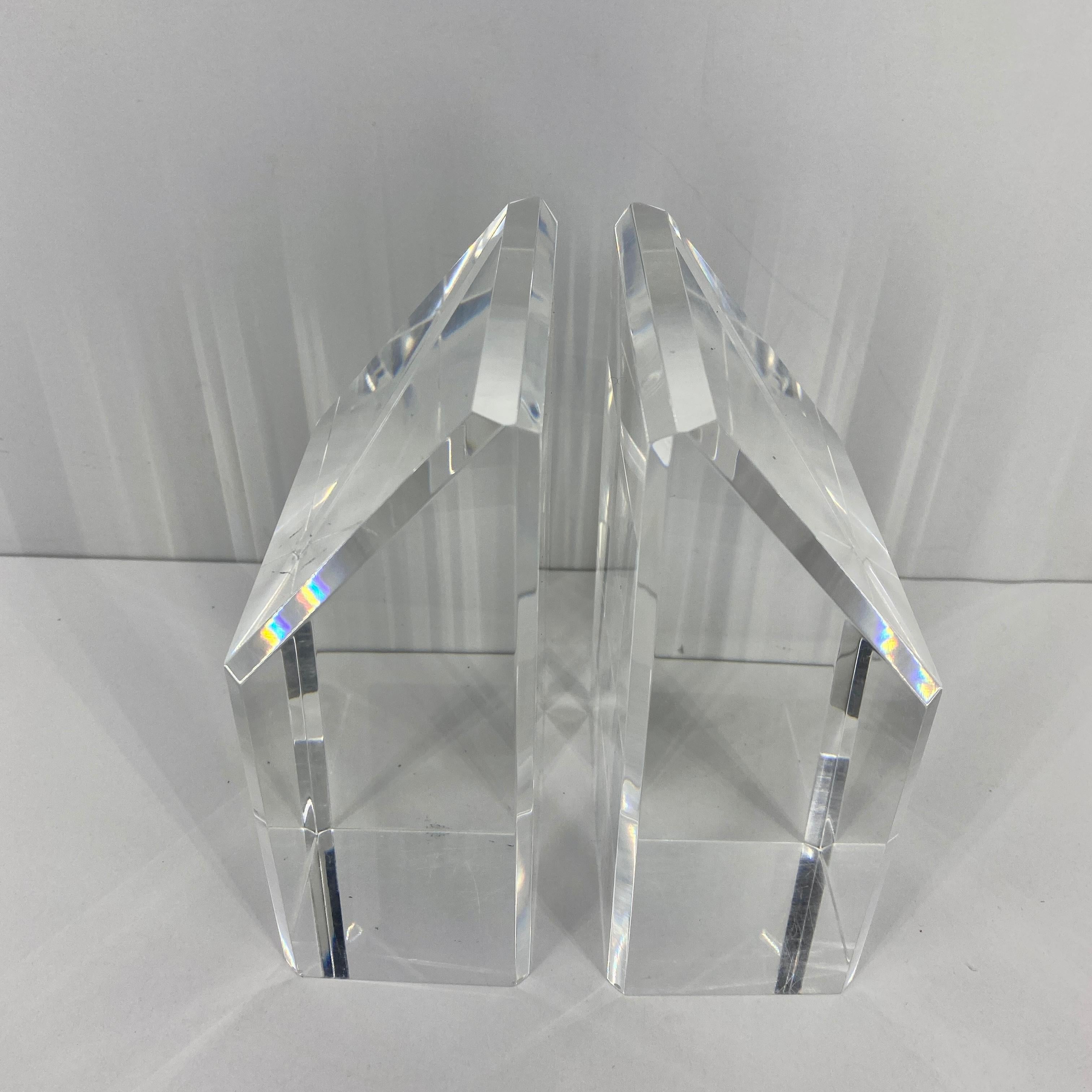 This is a beautiful polished and beveled pair of Lucite bookends. The size is perfect for all sizes of books. The light plays off it's dramatic sloped form almost making the bookends glow. This Lucite set is perfect for display in any modern setting.