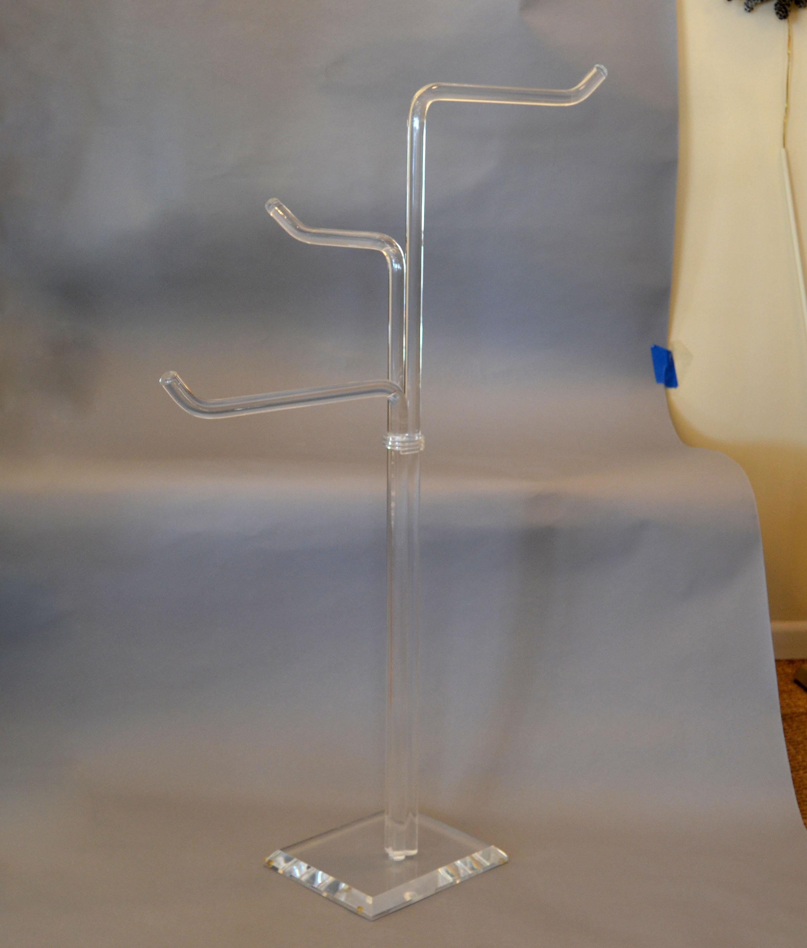 Unique Mid-Century Modern freestanding Lucite coat rack, coat stand, clothes tree.
The vintage design features three thick tubular Lucite Branches mounted on a rectangular Lucite base.
Useful for coats, jackets, clothes and hats.
 