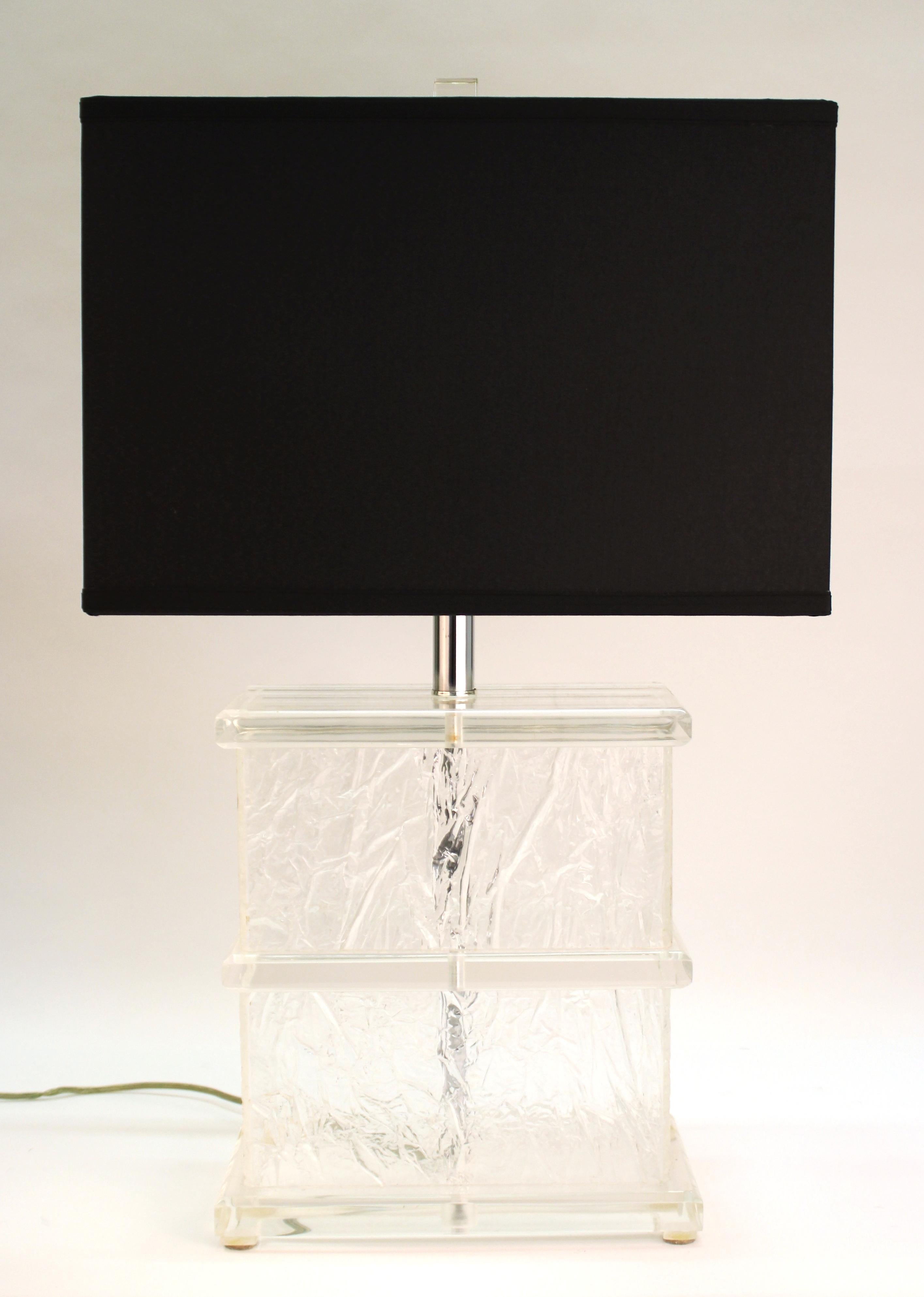 American Mid-Century Modern pair of Lucite crackle table lamps with new black shades and Lucite finials. The pair was made in the United States during the 1970s and is in excellent vintage condition, with new black shades.