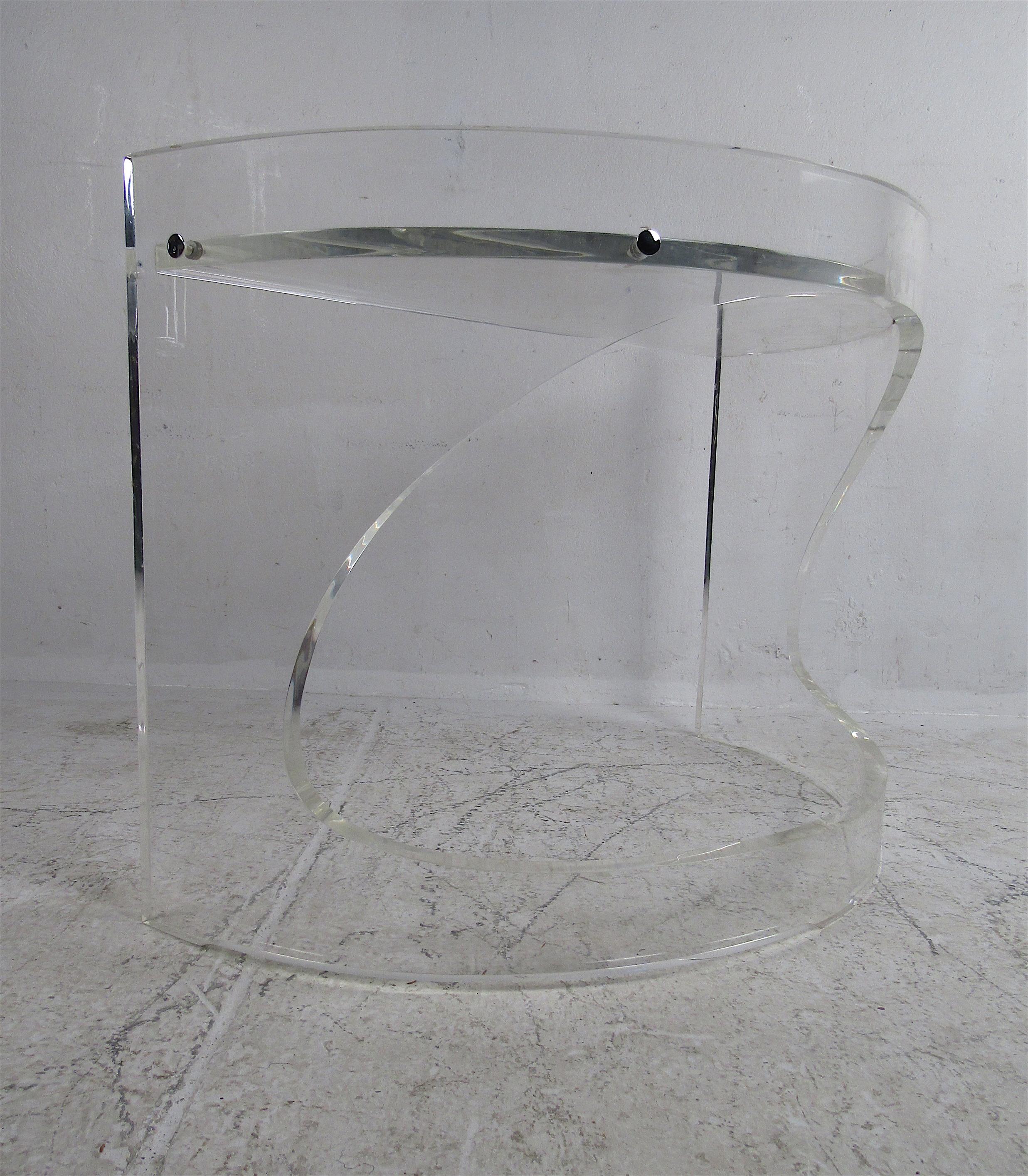 This stunning vintage modern console table boasts an ellipse-shaped design that adds style and grace to any setting. A thick versatile Lucite frame allows this piece to function as a simple dry bar. A wonderful and unusual mid-century piece that