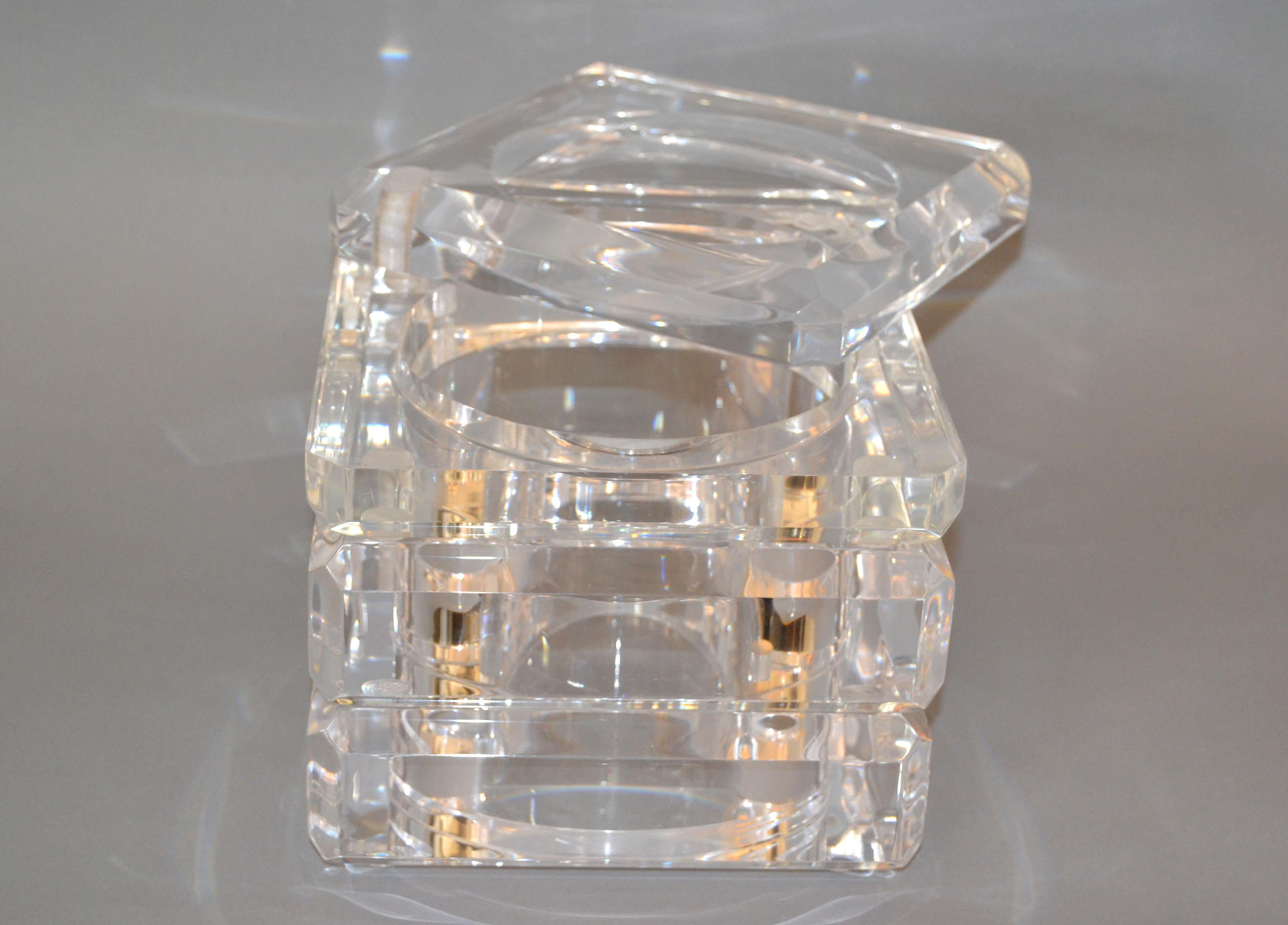 Mid-Century Modern finely detailed ice bucket in Lucite.
The tight fitted lid swings open and is attached to the bucket.
It is made out of very thick Lucite and is heavy.