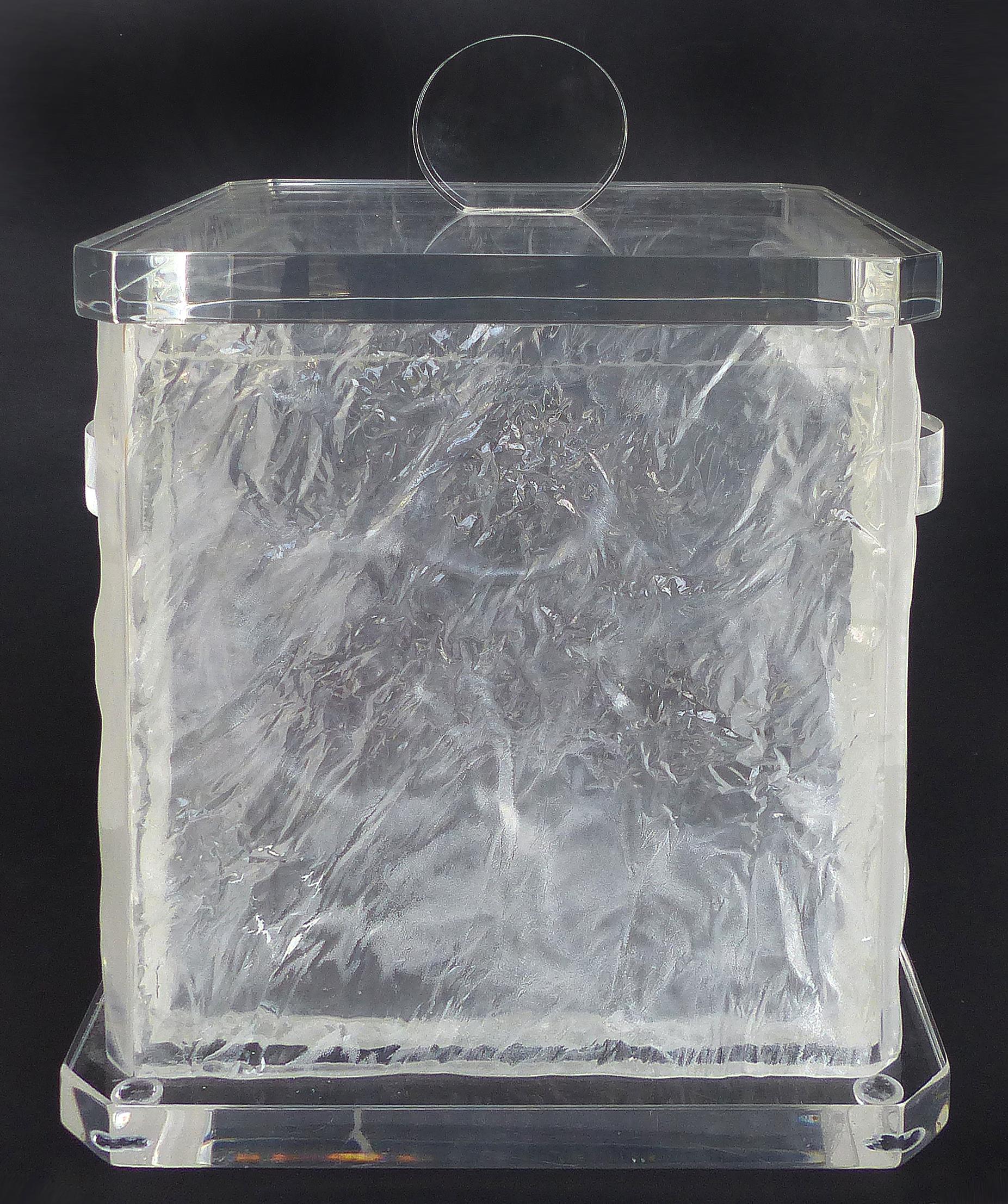 Mid-Century Modern Lucite Ice Bucket with Liner and Cover

Offered for sale is a substantial Mid-Century Modern Lucite ice bucket with liner and cover. The bucket mixes thick polished Lucite with a chipped-ice textured body. This large and heavy ice